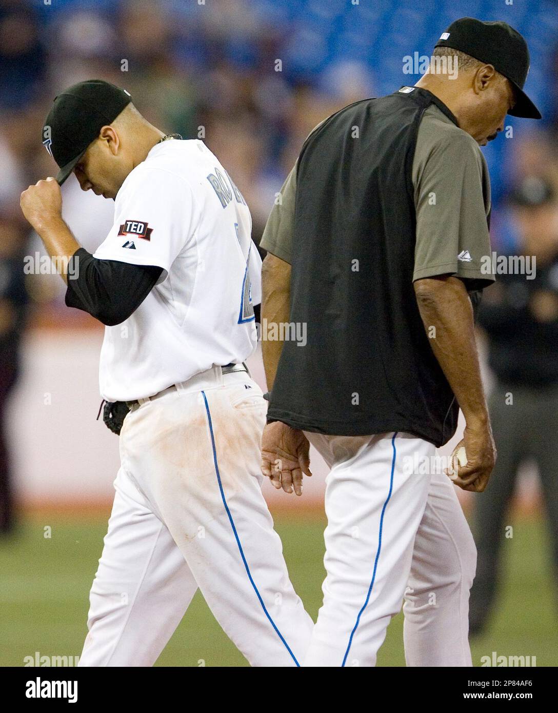 Toronto Blue Jays pitcher Ricky Romero, left, leaves the mound after  manager Cito Gaston, right, pulled him from the game during the fifth  inning of a baseball game against the New York