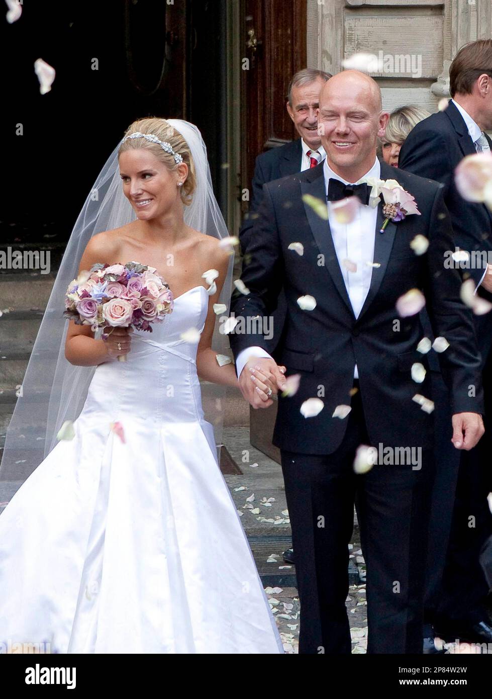 White rose petals are thrown into the air as ice hockey player Mats Sundin leaves the church of Maria Magdalena in central Stockholm, Saturday, Aug. 29, 2009, together with his bride Josephine Johansson. Sundin has played in the NHL for the last eighteen years and 1997 to 2008 he was the team captain of Toronto Maple Leafs. (AP Photo/Scanpix Sweden/Roger Vikstrom) ** SWEDEN OUT ** Stock Photo