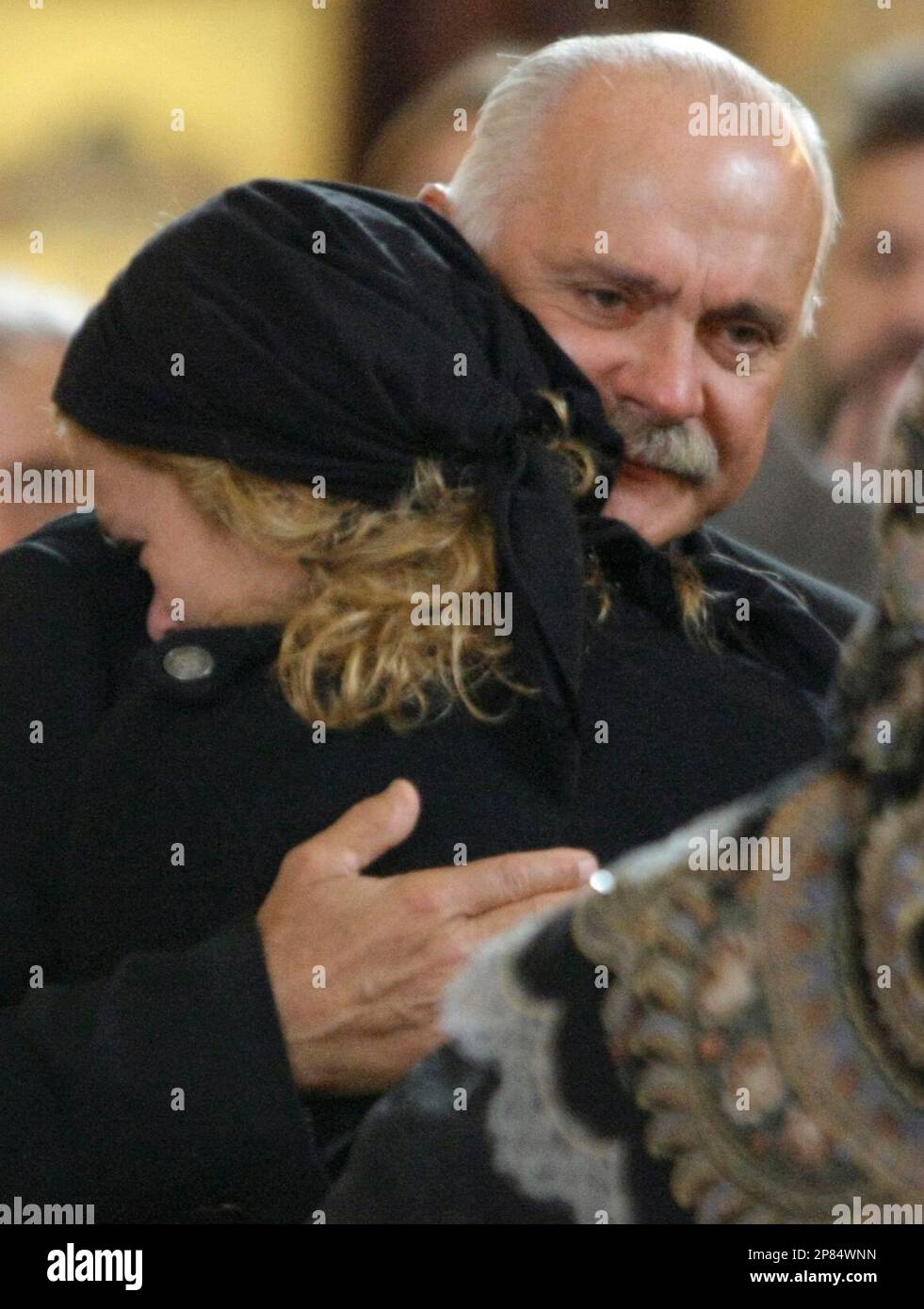 Oscar-winning film director Nikita Mikhalkov comforts his daughter Nadya as  they grieve at a funeral ceremony for his father and her grandfather Sergei  Mikhalkov in the Christ the Savior Cathedral in Moscow,
