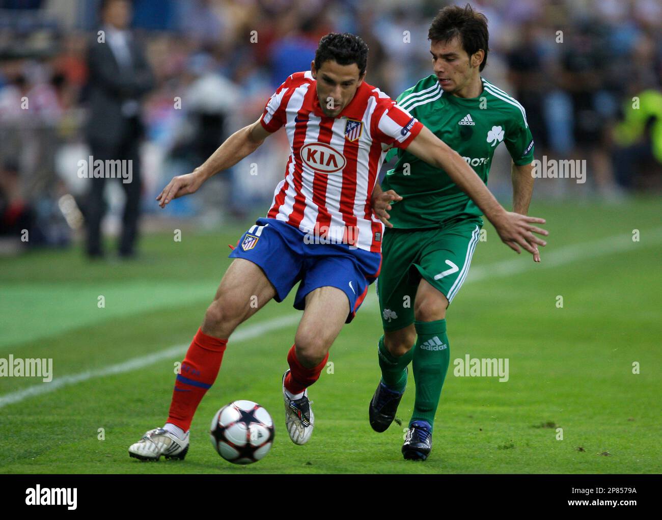 Atletico Madrid's Maxi Rodriguez from Argentina, left, vies for the ball  with Greece's Panathinaikos Sotiris Ninis, right, during their Champions  League second leg play-off soccer match at the Vicente Calderon stadium in
