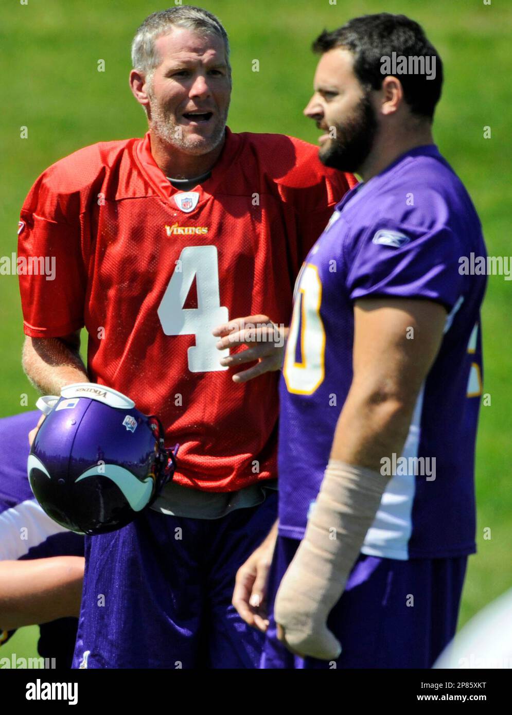 Minnesota Vikings' Jim Kleinsasser (40) gives a friendly slap to the helmet  to Vikings punter/holder Chris Kluwe after Ryan Longwell (right) kicked the  game winning field goal in overtime at the Metrodome