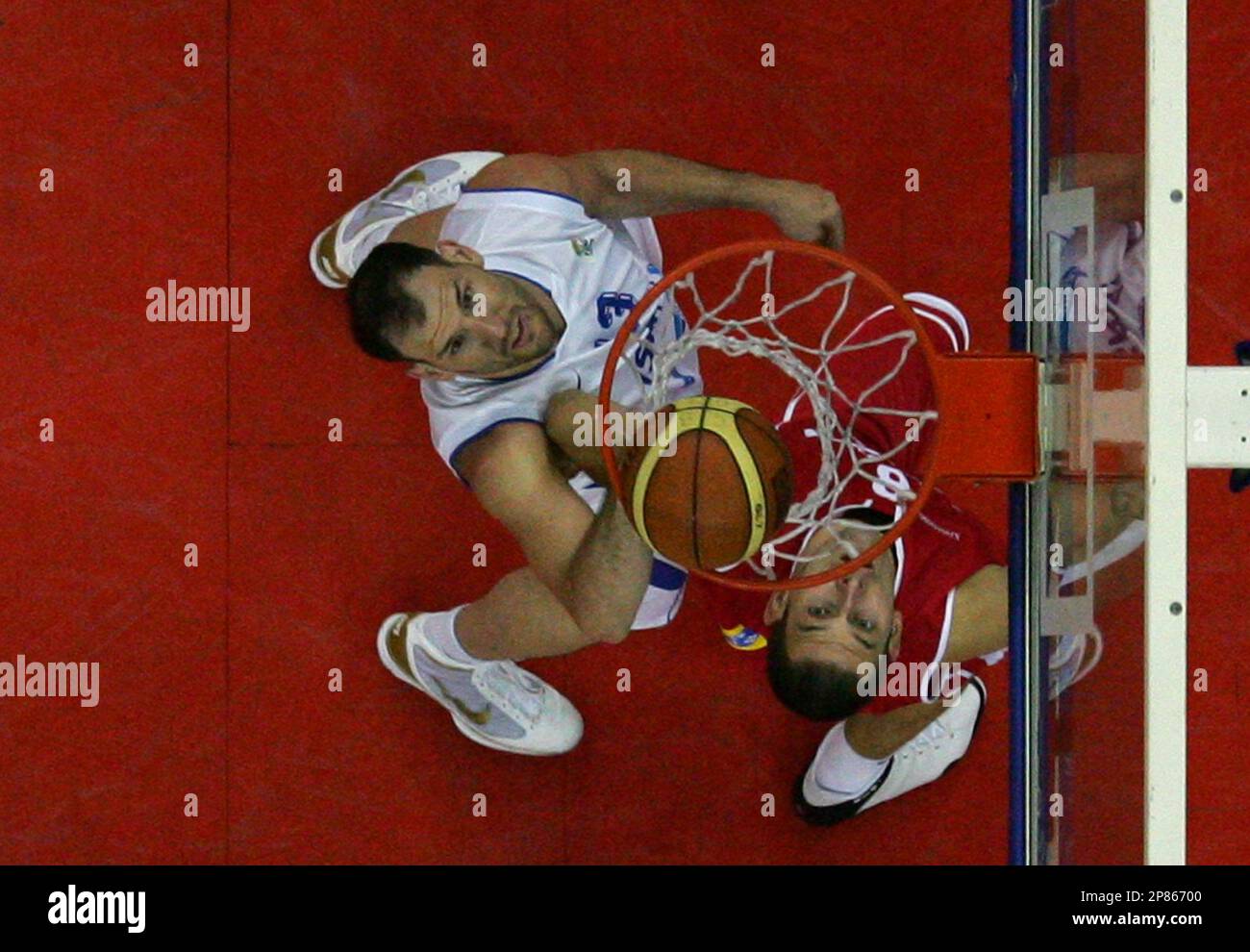 Poland's Filip Dylewicz, left, and Israel's Ido Kozikaro, left, jump