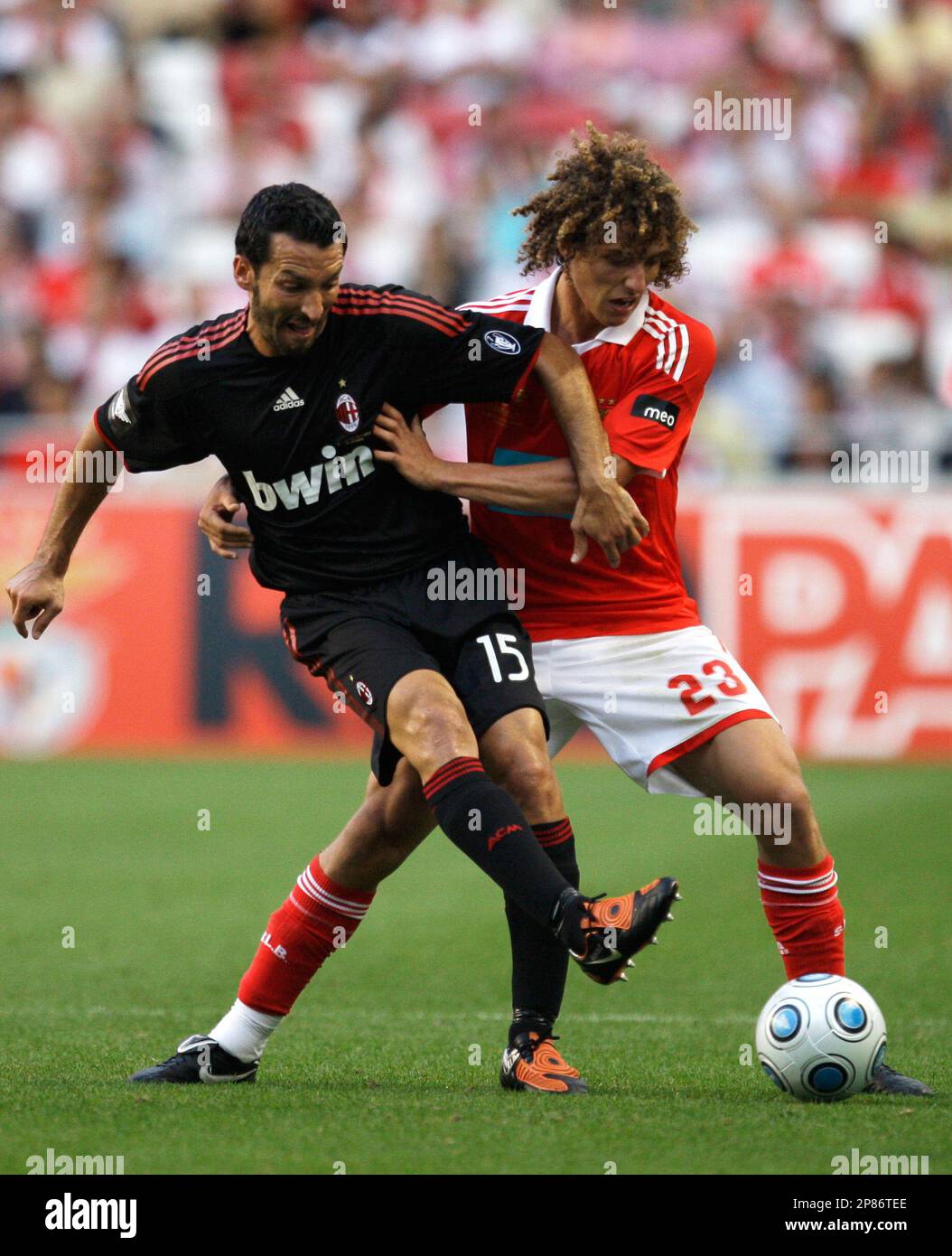 AC Milan's Zambrotta, left, fights for the ball with Benfica's David Luiz  during their Eusebio Cup soccer match Saturday, Aug. 8 2009, at Benfica's  Luz stadium in Lisbon. (AP Photo/Armando Franca Stock, image size:1054x1390