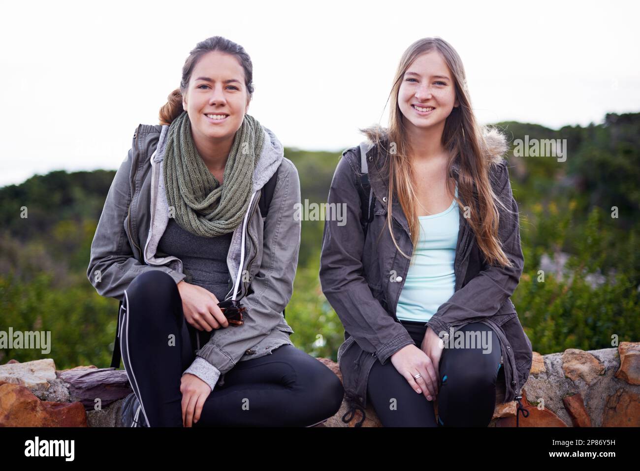 Hiking - their idea of fun. two attractive young female hikers in the ...