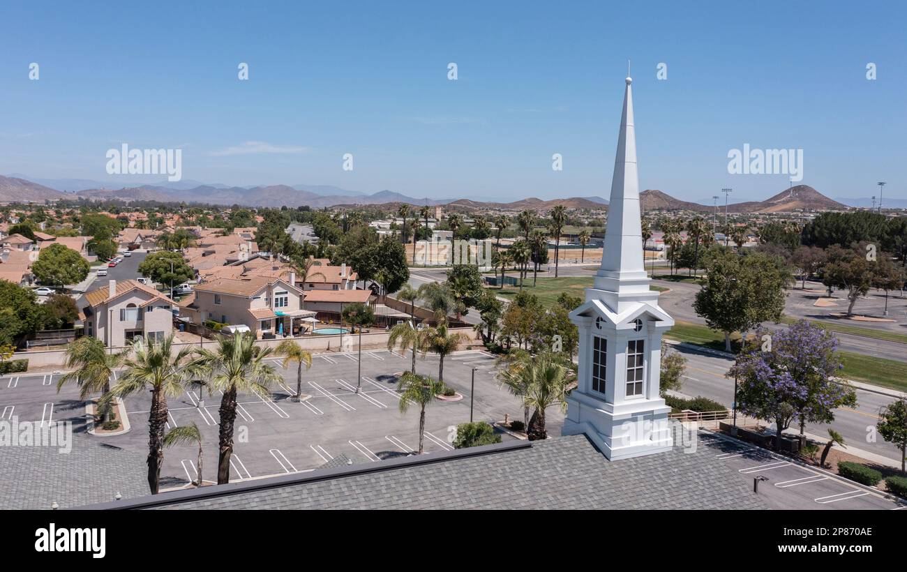 Aerial view of sprawling single family home neighborhood and church of