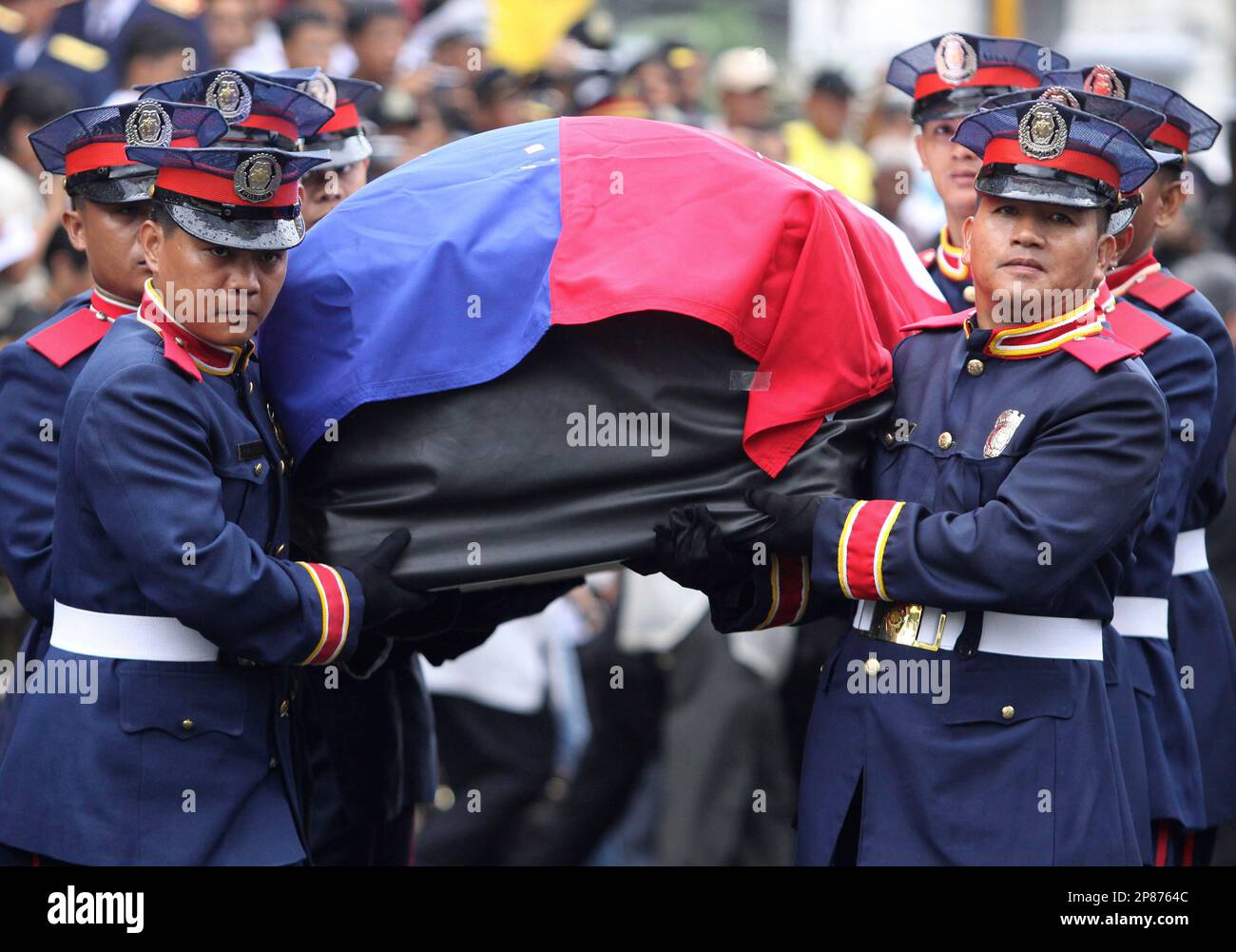 Honor guards carry the casket of the late former Philippine President Corazon Aquino during her