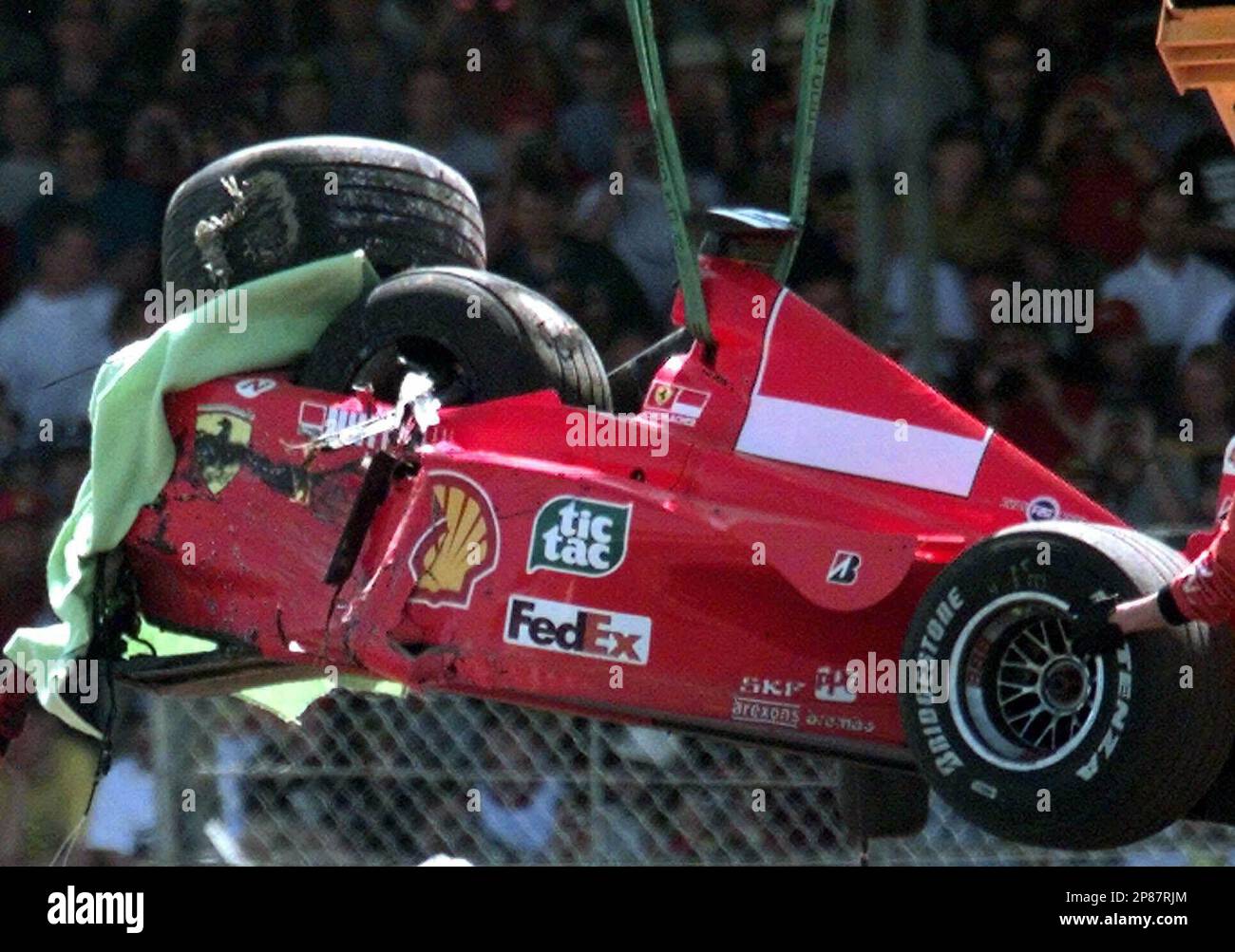 FILE - The July 11, 1999 file photo shows the damaged Ferrari of Germany's  Michael Schumacher is lifted onto a flat bed truck, after he crashed into a  tire wall on the