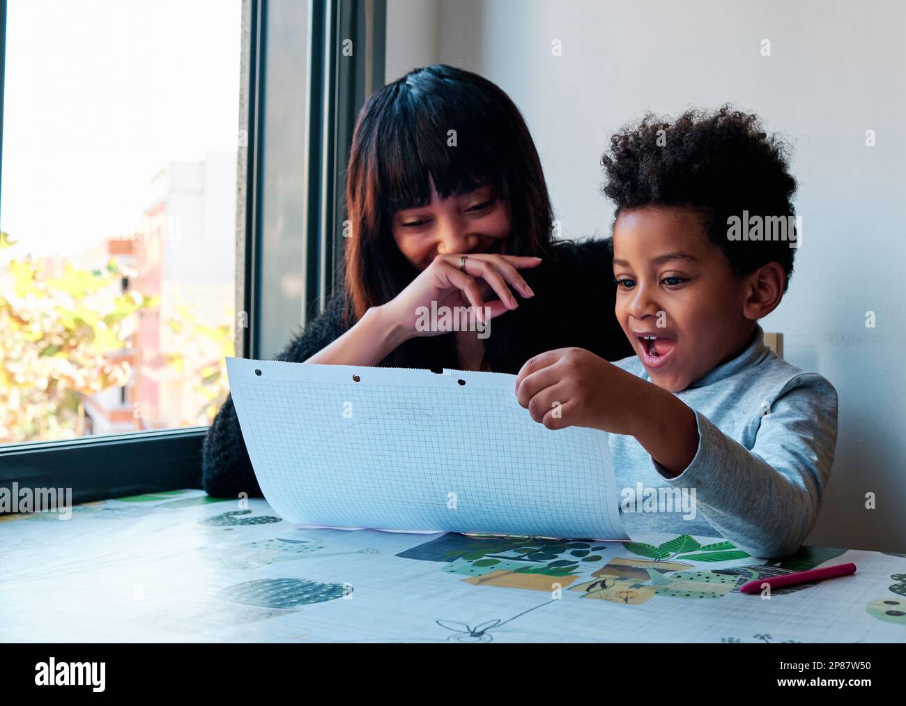 Cute mother son doing homework hi-res stock photography and images - Alamy