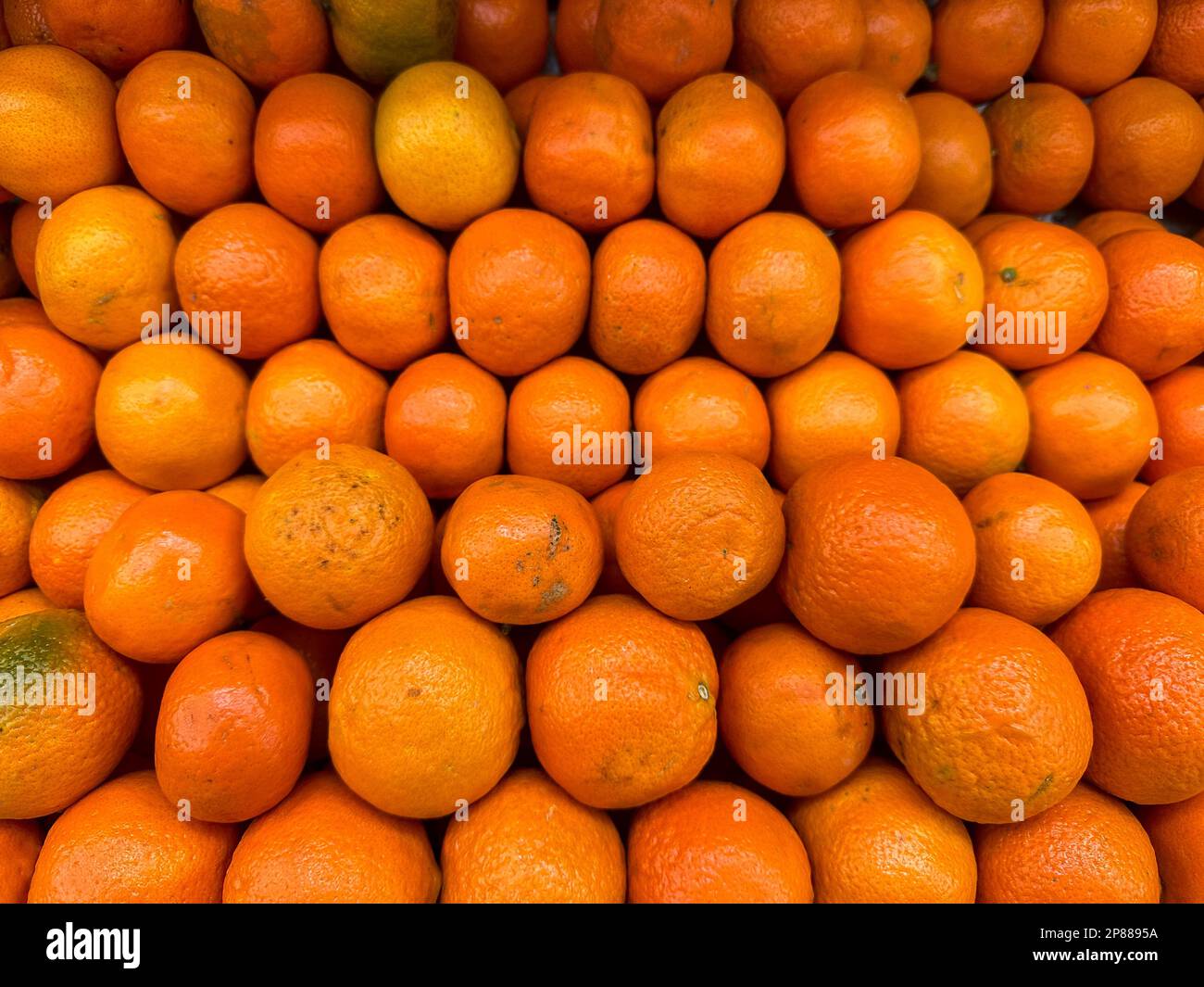 Fresh oranges on fruit market, close up. Boxes full of ripe oranges for