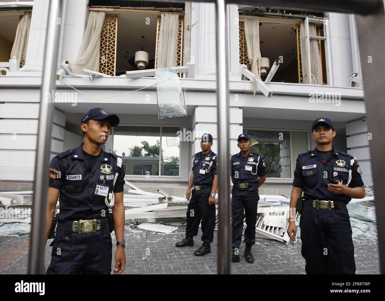 Indonesian police officers stand guard on the grounds of the Ritz ...