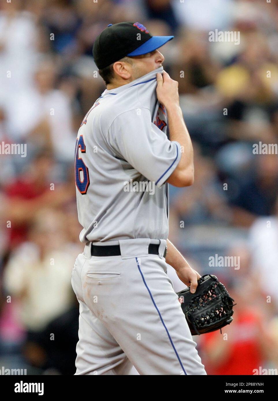 New York Mets starter Oliver Perez wipes his face after allowing a solo  home run to Atlata Braves' Yunel Escobar in the second inning of a baseball  game in Atlanta, Thursday, July