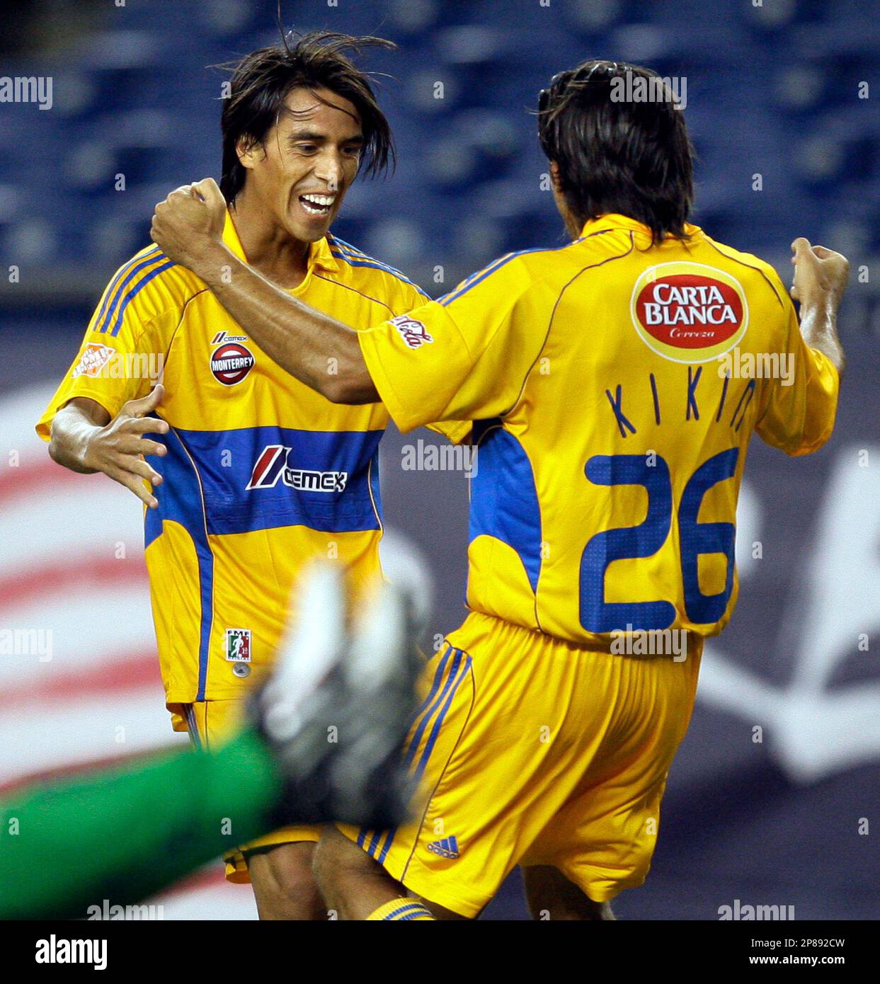 Tigres UANL's Lucas Lobos, left, celebrates with Jose Francisco Fonseca  (26) after Fonseca's goal against Santos Laguna in the first half of a  SuperLiga semifinal soccer match in Foxborough, Mass., Wednesday, July