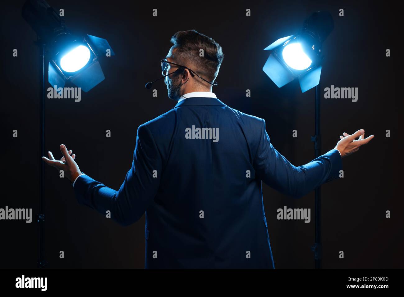 Motivational speaker with headset performing on stage, back view Stock ...