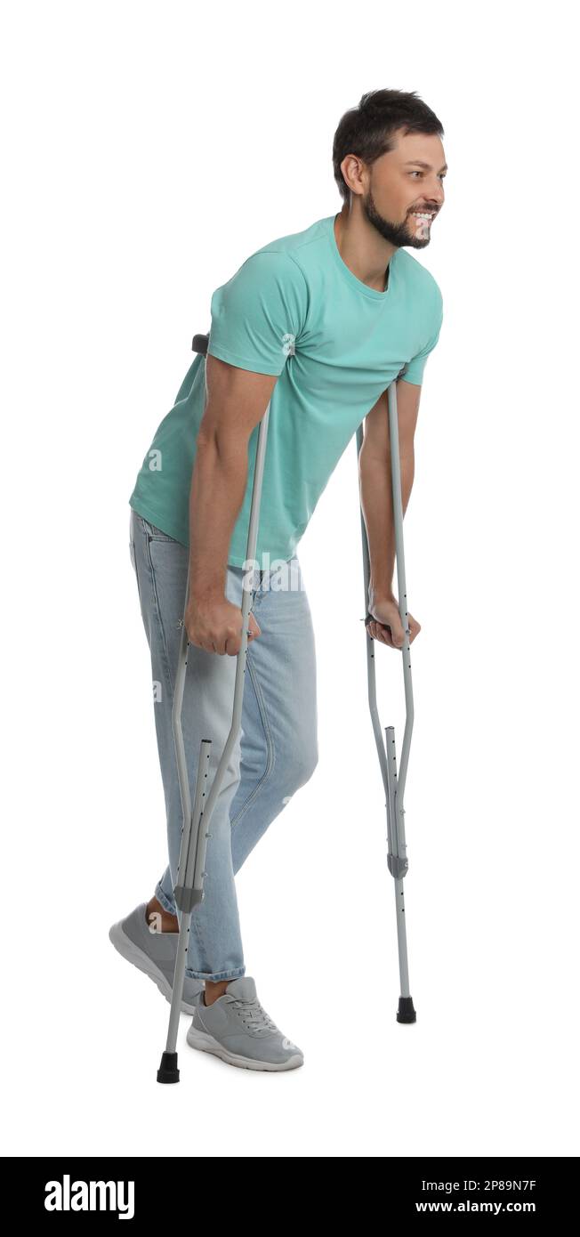 Full length portrait of man with crutches on white background Stock