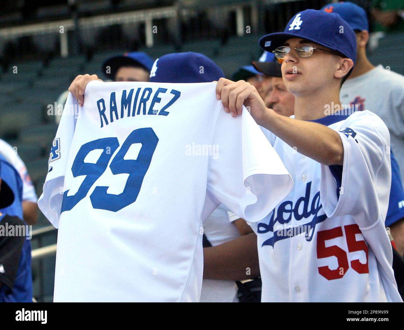A fan holds up a jersey for Los Angeles Dodgers' Manny Ramirez