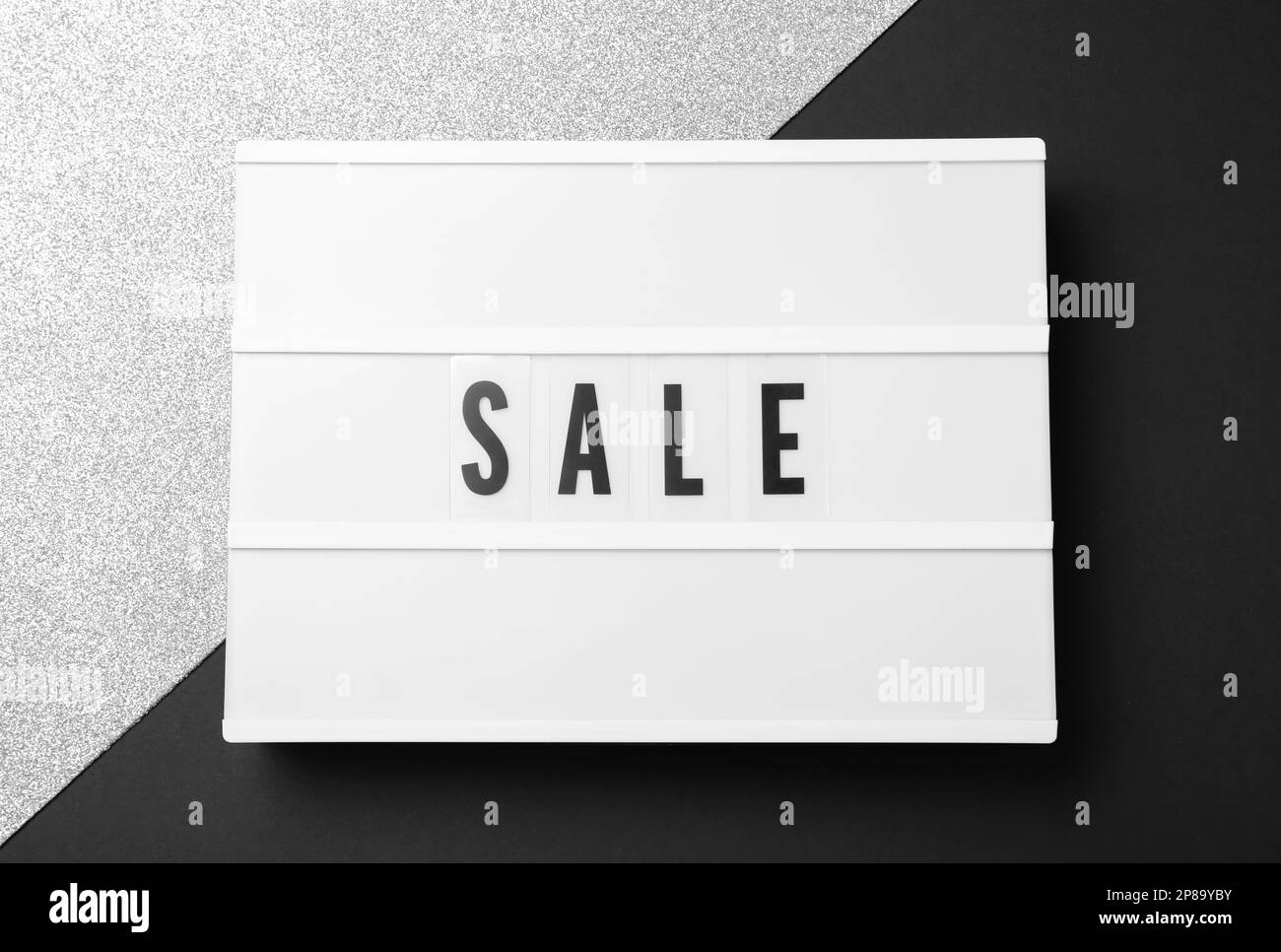 Lightbox with word Sale on color background, top view. Black Friday