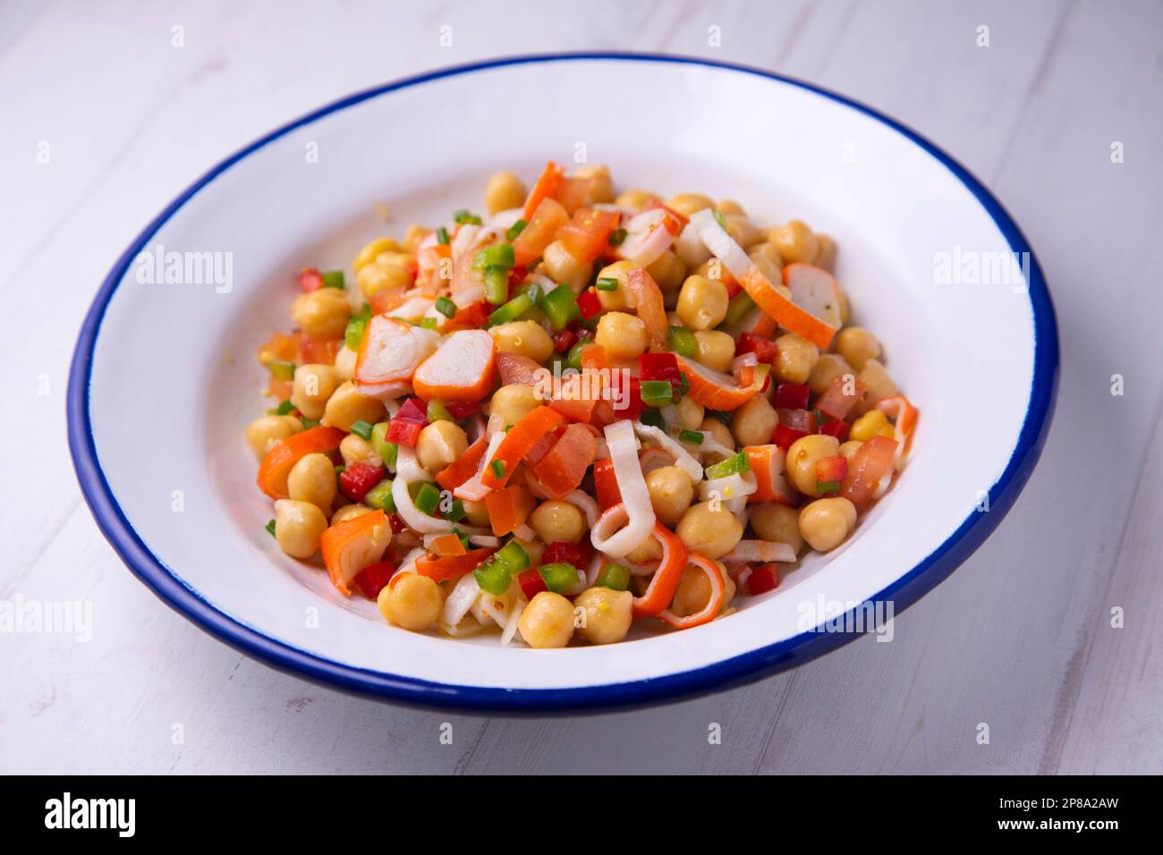 Delicious and healthy chickpea salad with crab surimi. Stock Photo
