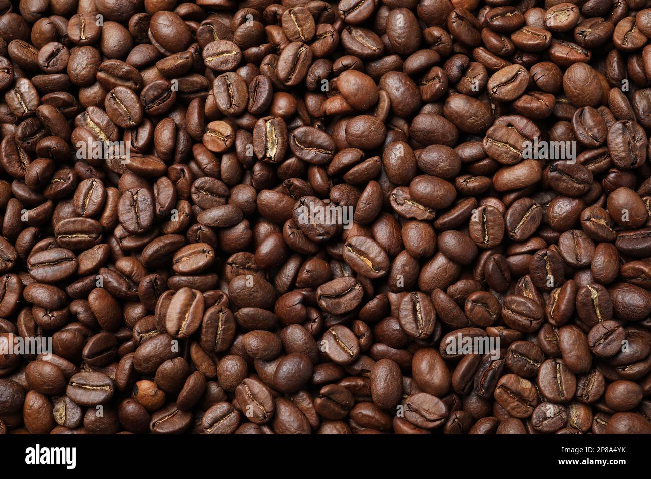 Pile of roasted coffee beans as background, top view Stock Photo - Alamy