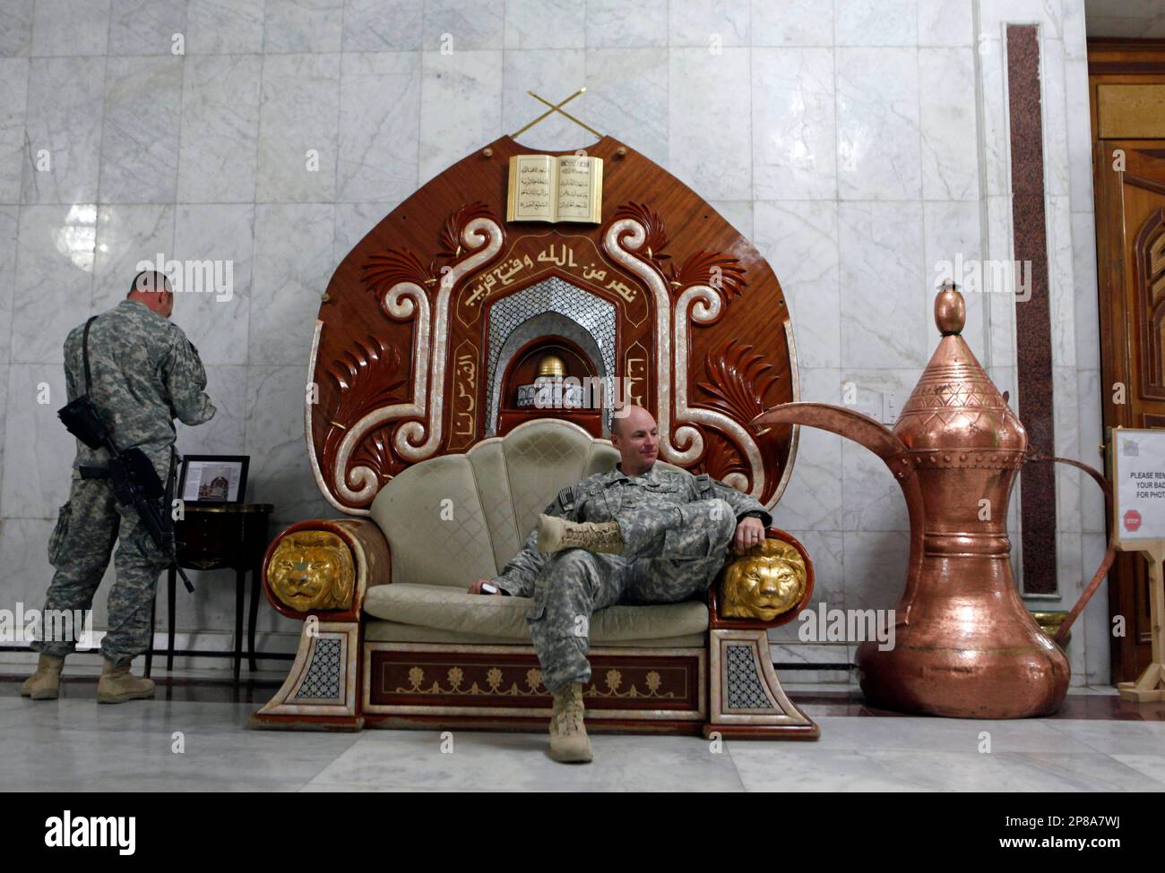 A U.S. Army soldier relaxes on an armchair, believed to have belonged