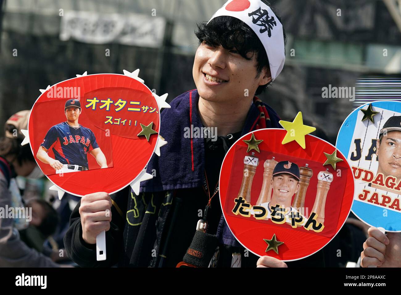 A fan of Japan's Shohei Ohtani and Lars Nootbaar cheer prior to the