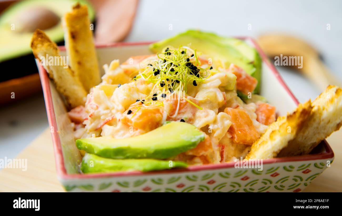 Delicious salad with mayonnaise, avocado and carrot. Stock Photo