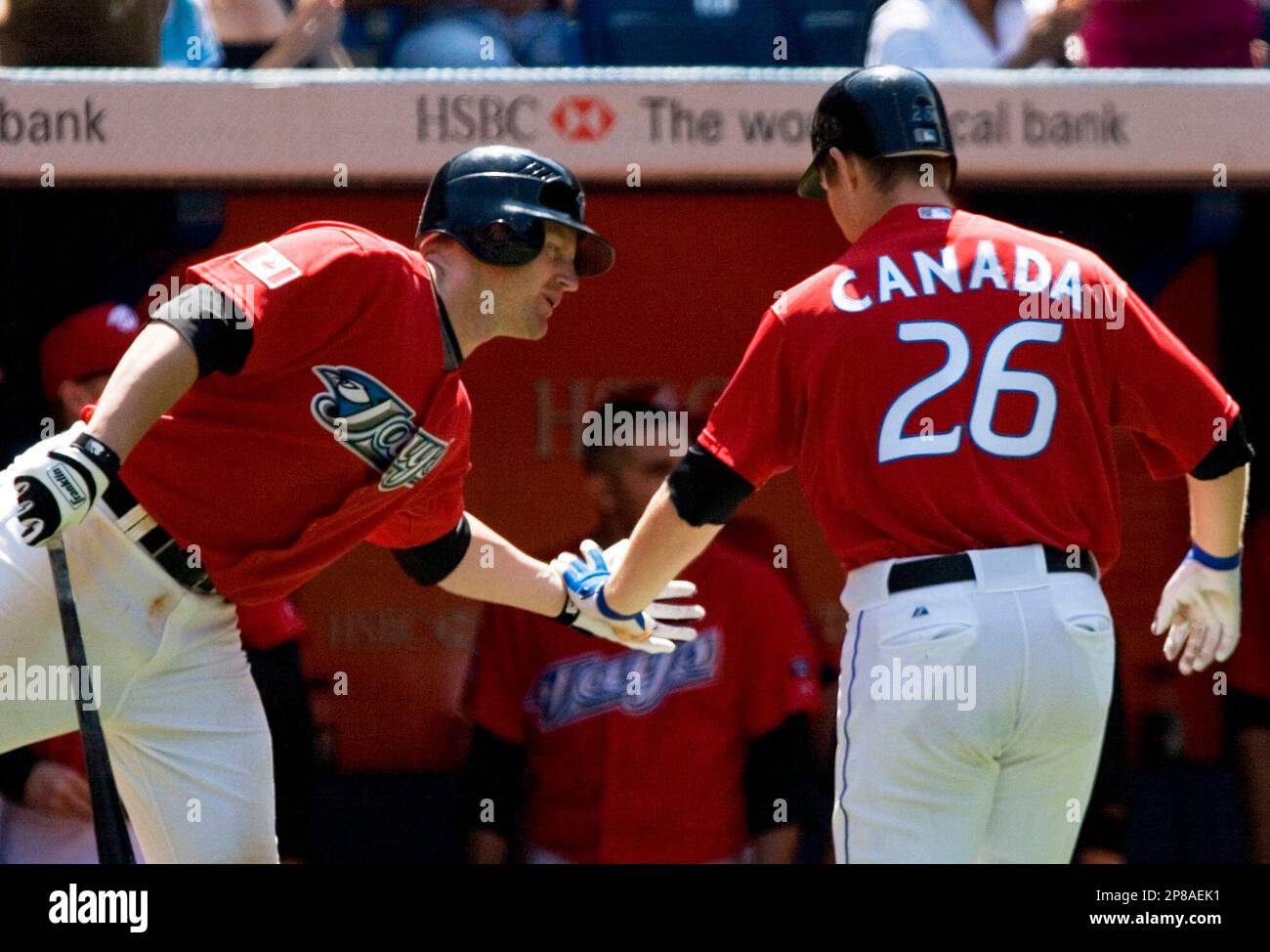 Toronto Blue Jays' Adam Lind, right, celebrates his eighthinning solo