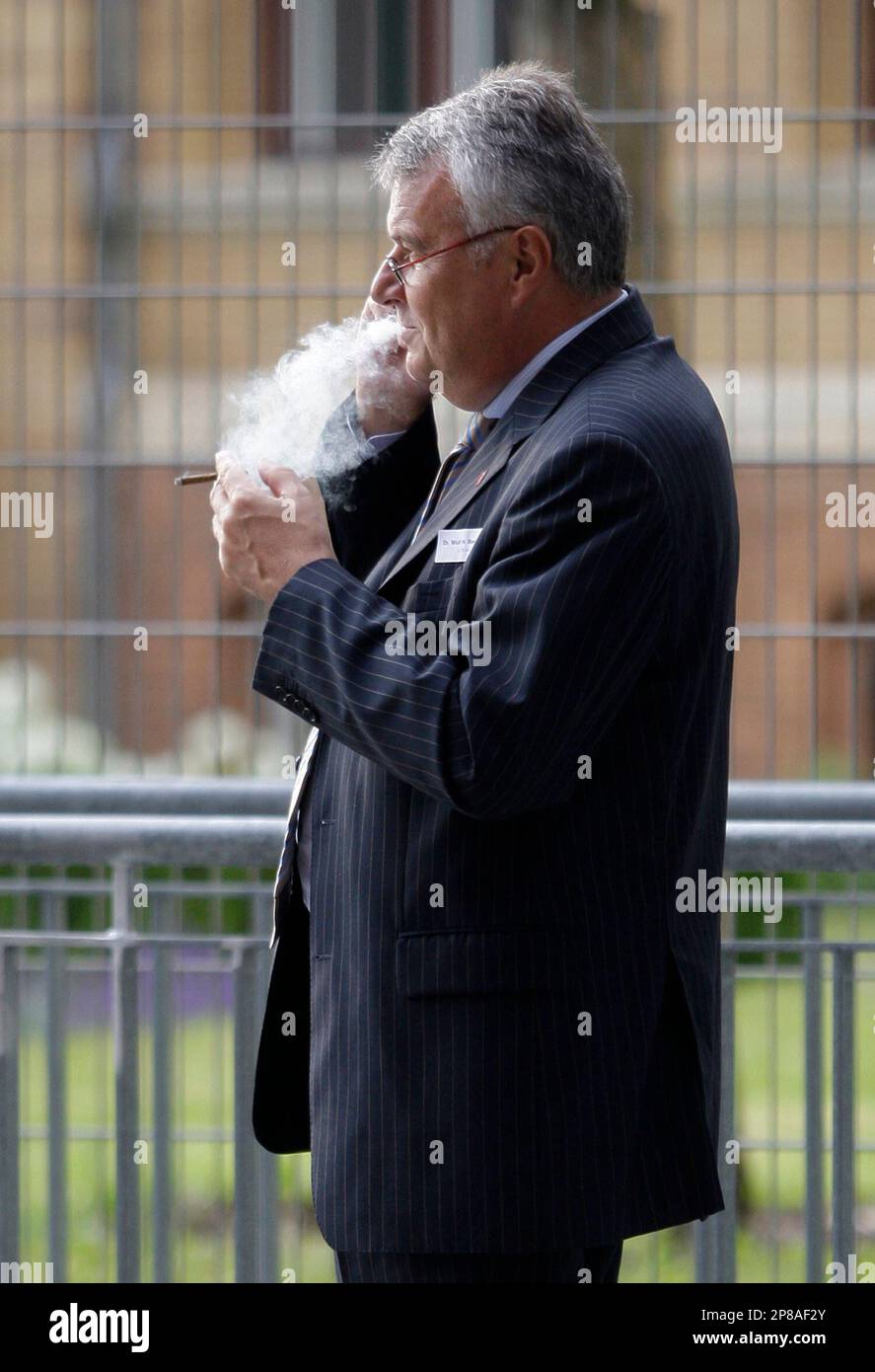 Wulf Bernotat, CEO of German power utility E.ON, smokes a cigarette before  the celebrations marking the 50th anniversary of the German Atomic Forum  (DAtF) in Berlin, Wednesday July 1, 2009. (AP Photo/Tobias