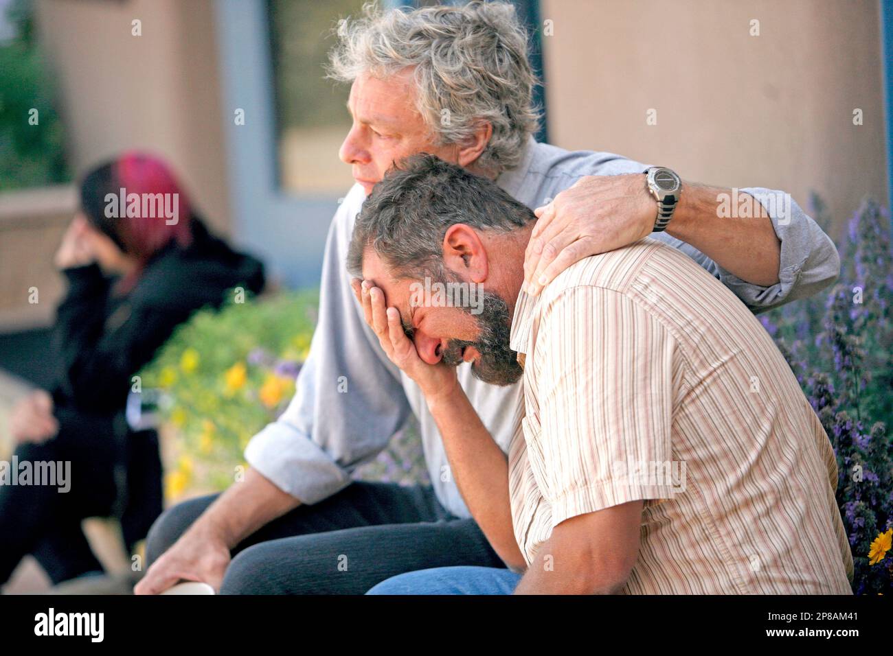 Barry Klein, father of Kate Klein, is comforted by his friend Scott  Lindquist at Santa Fe Prep on Monday, June 29, 2009, during a gathering of  friends and family. Four teenagers were