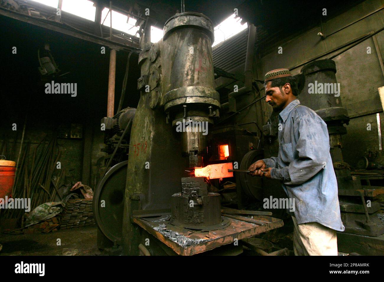 A Pakistani worker prepares an iron tool at the site of a conventional