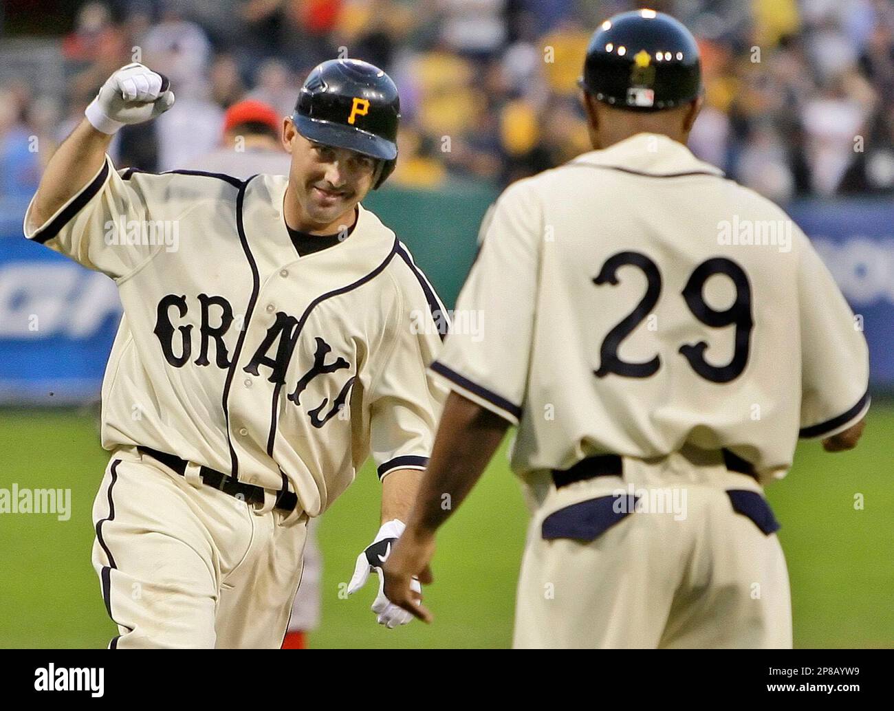 Pittsburgh Pirates' Jack Wilson, left, is greeted by teammates Umberto  Cota, Jose Castillo, center, right, and Michael Restovich after hitting a  grand slam in the seventh inning of the Pirates 11-4 win