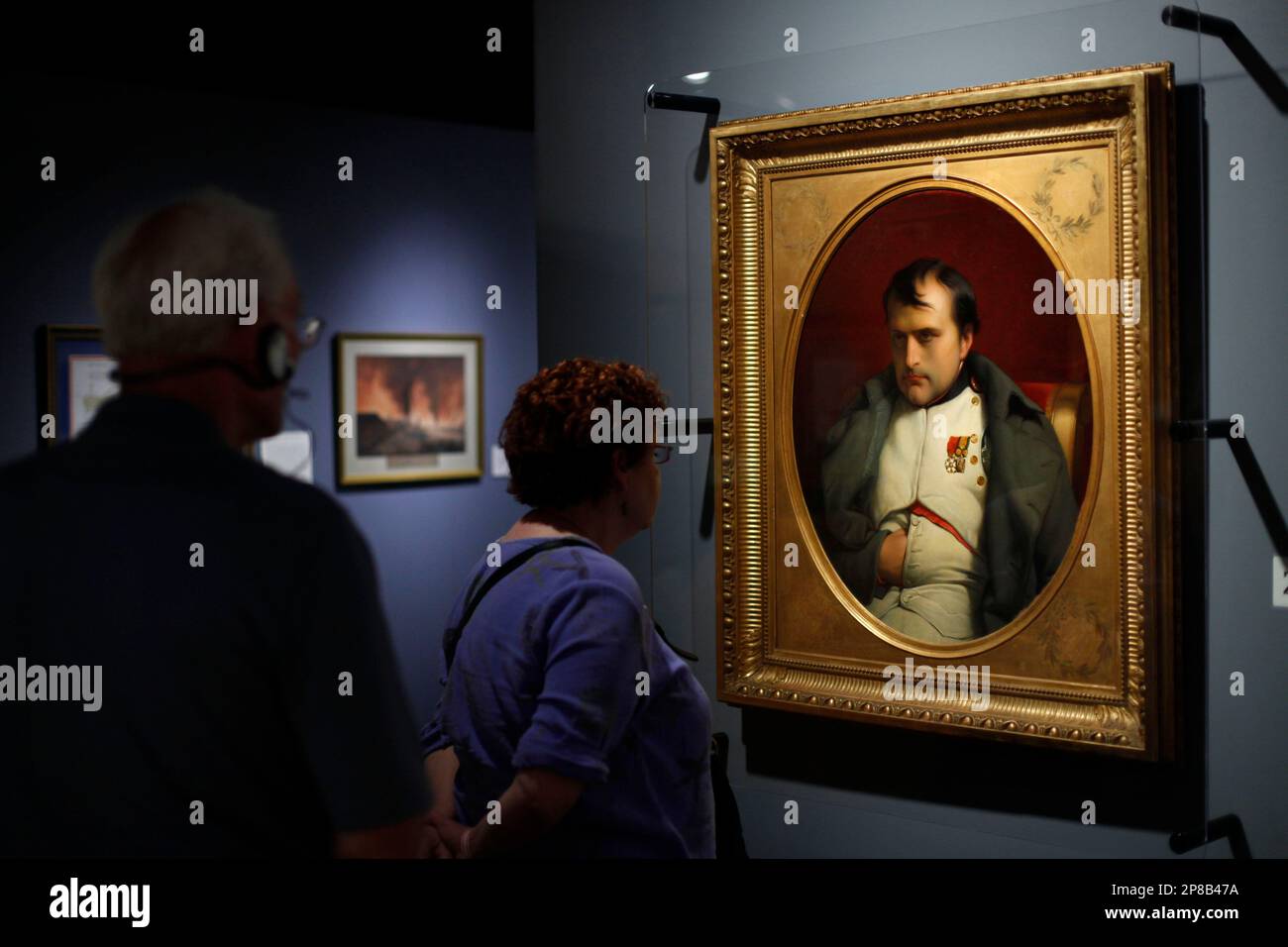 People view a painting by Paul Hippolyte Delaroche of Napoleon Bonaparte on display at the