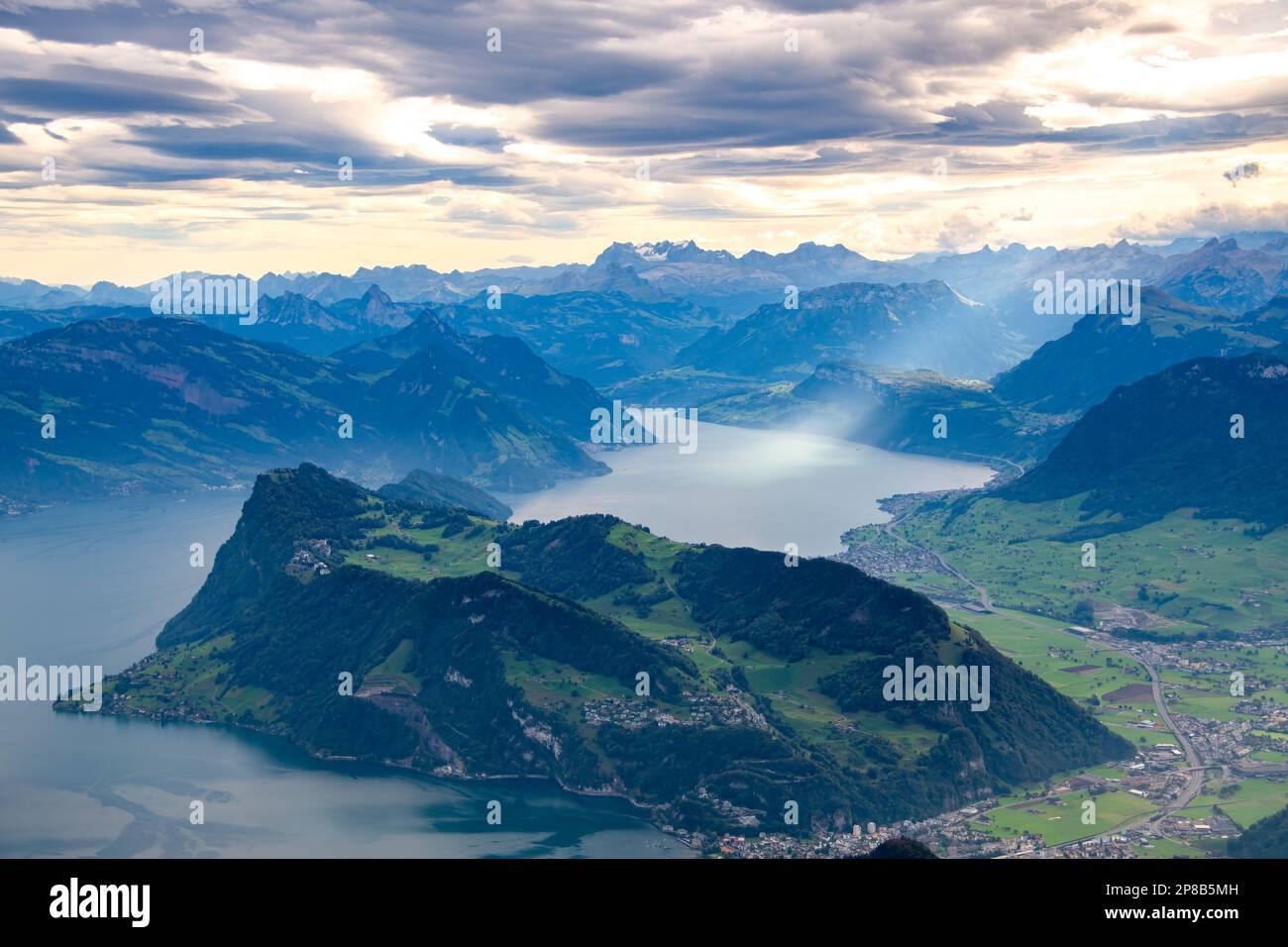Mountain and lake landscape a ray of light breaks through the clouds Stock Photo