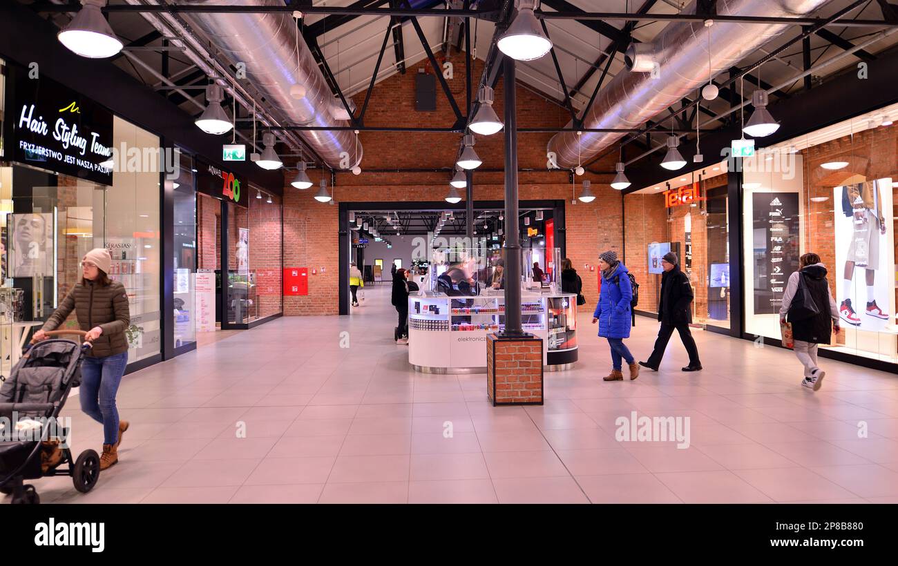 Warsaw, Poland. 8 March 2023. People walking in a shopping mall past