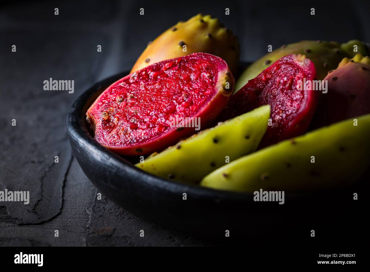 Prickly pear in black bowl on black background Stock Photo