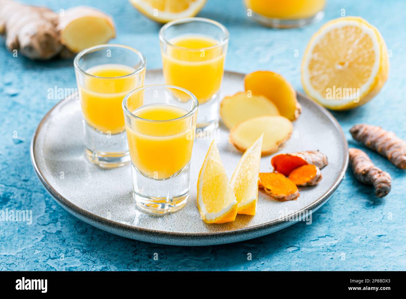 Boosting immune system - homemade healthy Ginger Lemon Turmeric Shot with ingredients Stock Photo