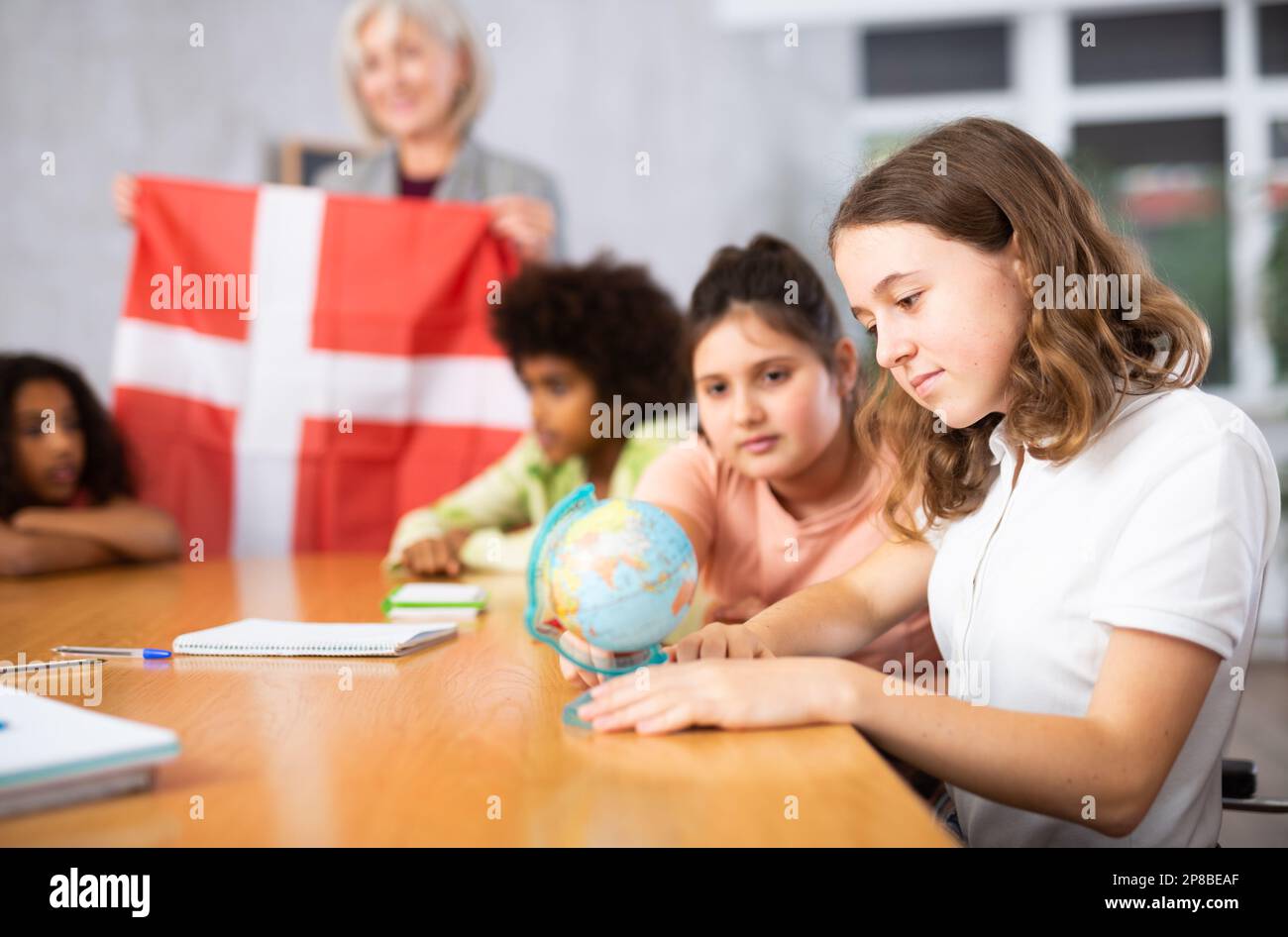 students listen to the teacher who talks about Denmark Stock Photo