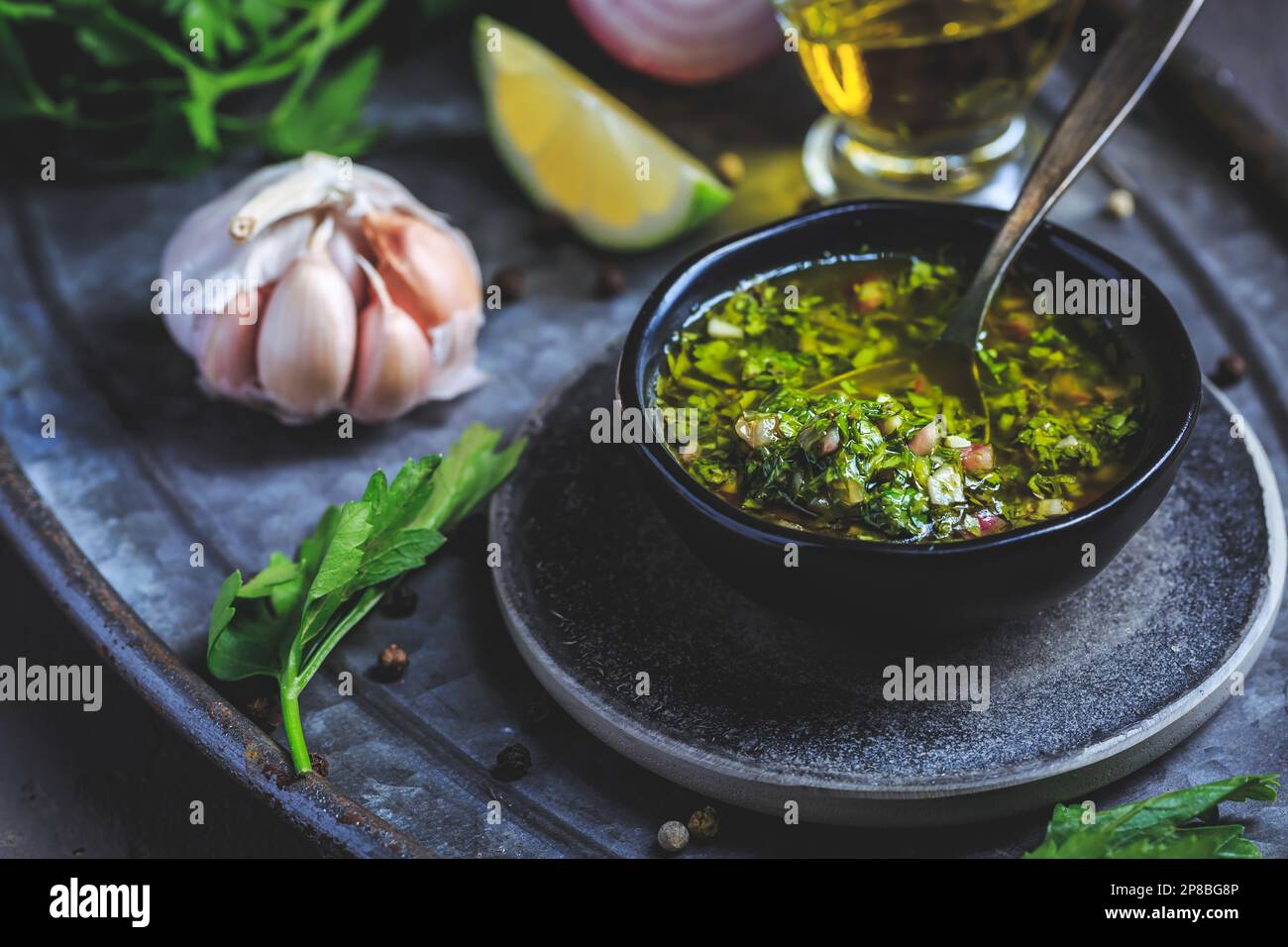 Chimichurri verde - traditional Argentine condiment, made from finely chopped parsley, minced garlic, olive oil, oregano, and wine vinegar Stock Photo