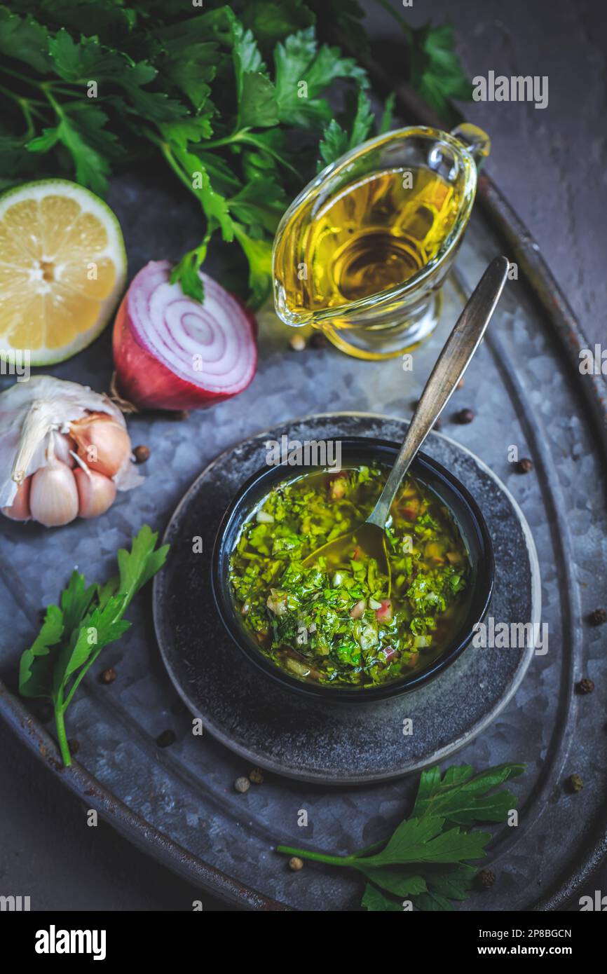 Chimichurri verde - traditional Argentine condiment, made from finely chopped parsley, minced garlic, olive oil, oregano, and wine vinegar Stock Photo