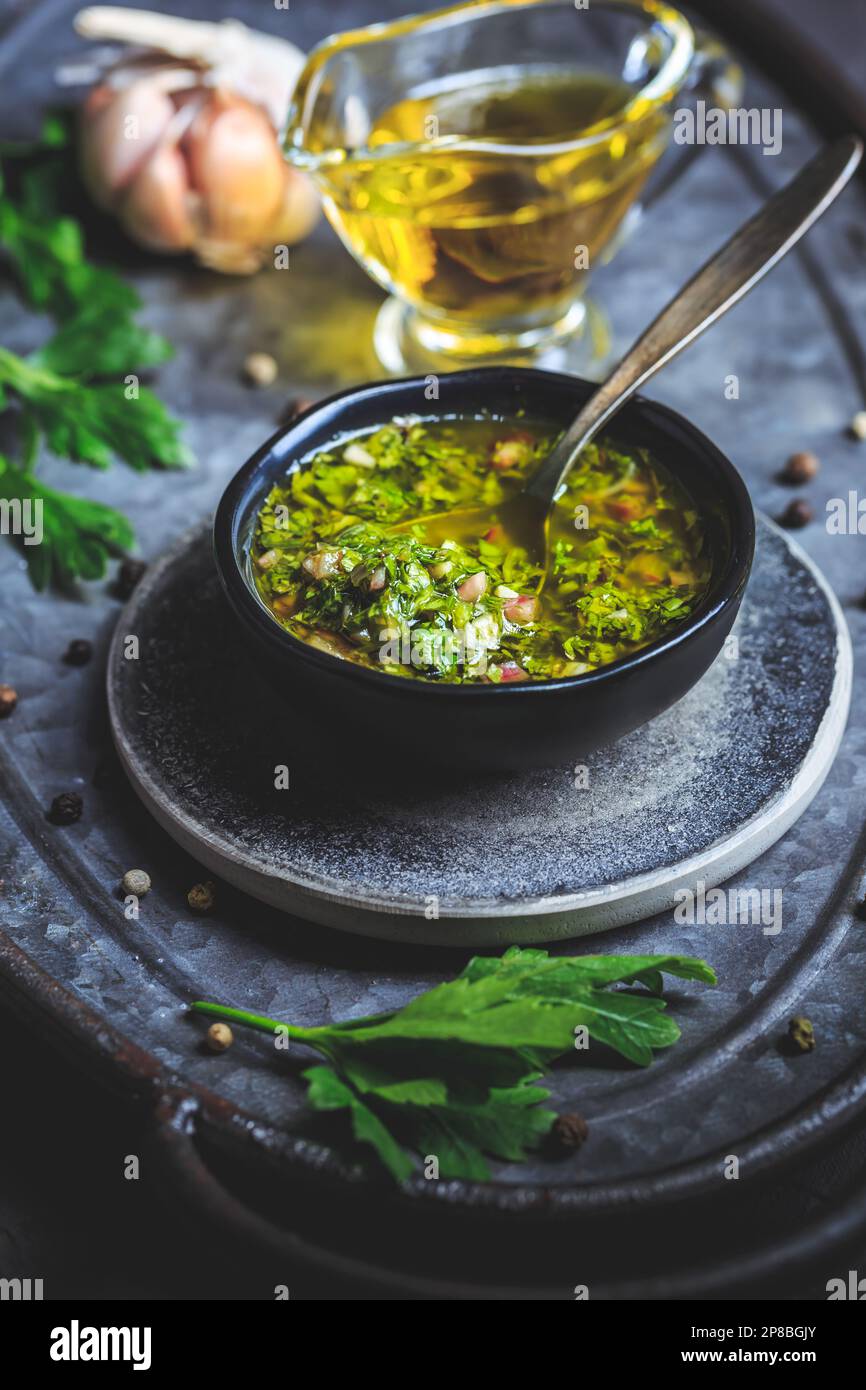 Chimichurri verde - traditional Argentine condiment, made from finely chopped parsley, minced garlic, olive oil, oregano, and wine vinegar Stock Photo