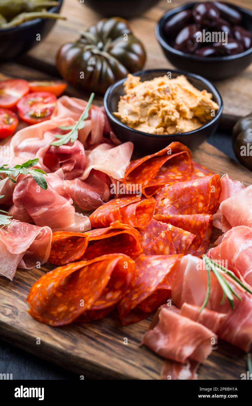 Charcuterie board with prosciutto ham, salami, olives and tapas Stock
