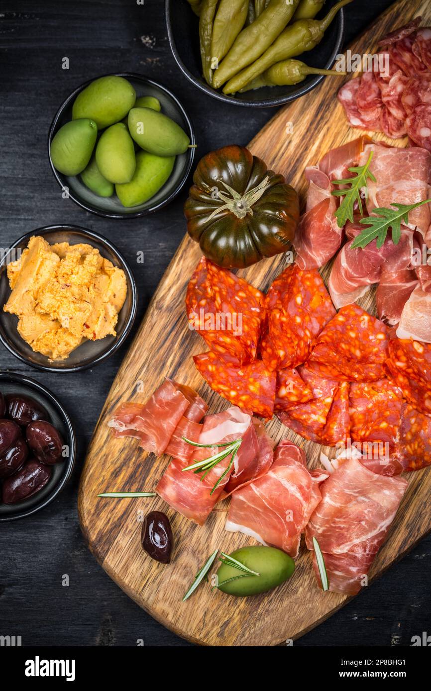 Charcuterie board with prosciutto ham, salami, olives and tapas Stock