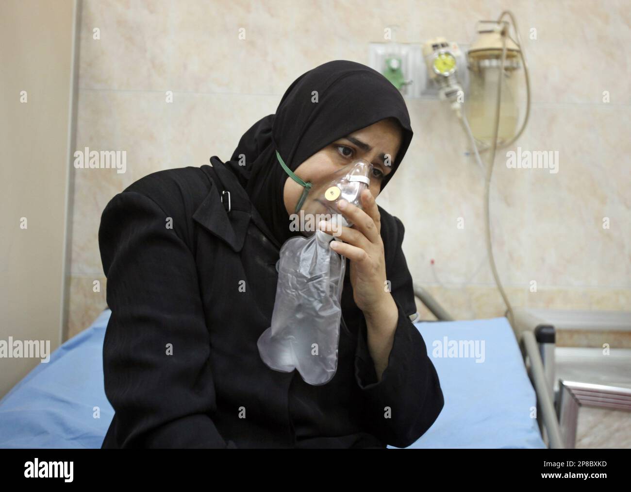 A woman is treated for smoke inhalation from a fire at the Iraqi Health ...
