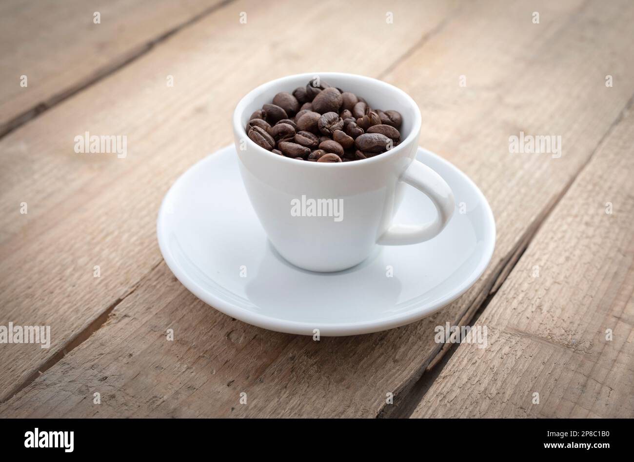 Coffee cup with roasted beans on wooden background Stock Photo