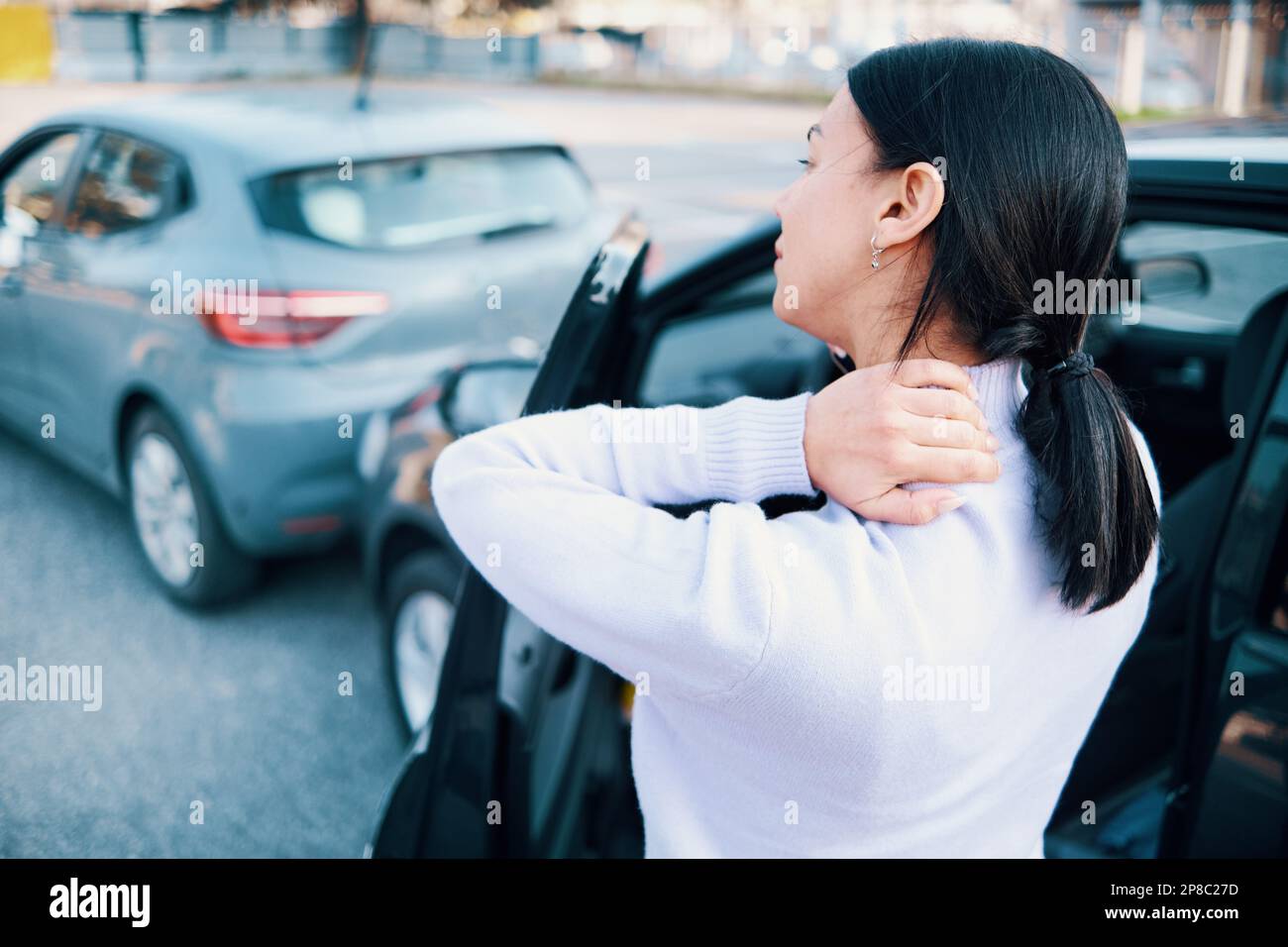 Woman suffering neck pain after car accident pileup Stock Photo Alamy