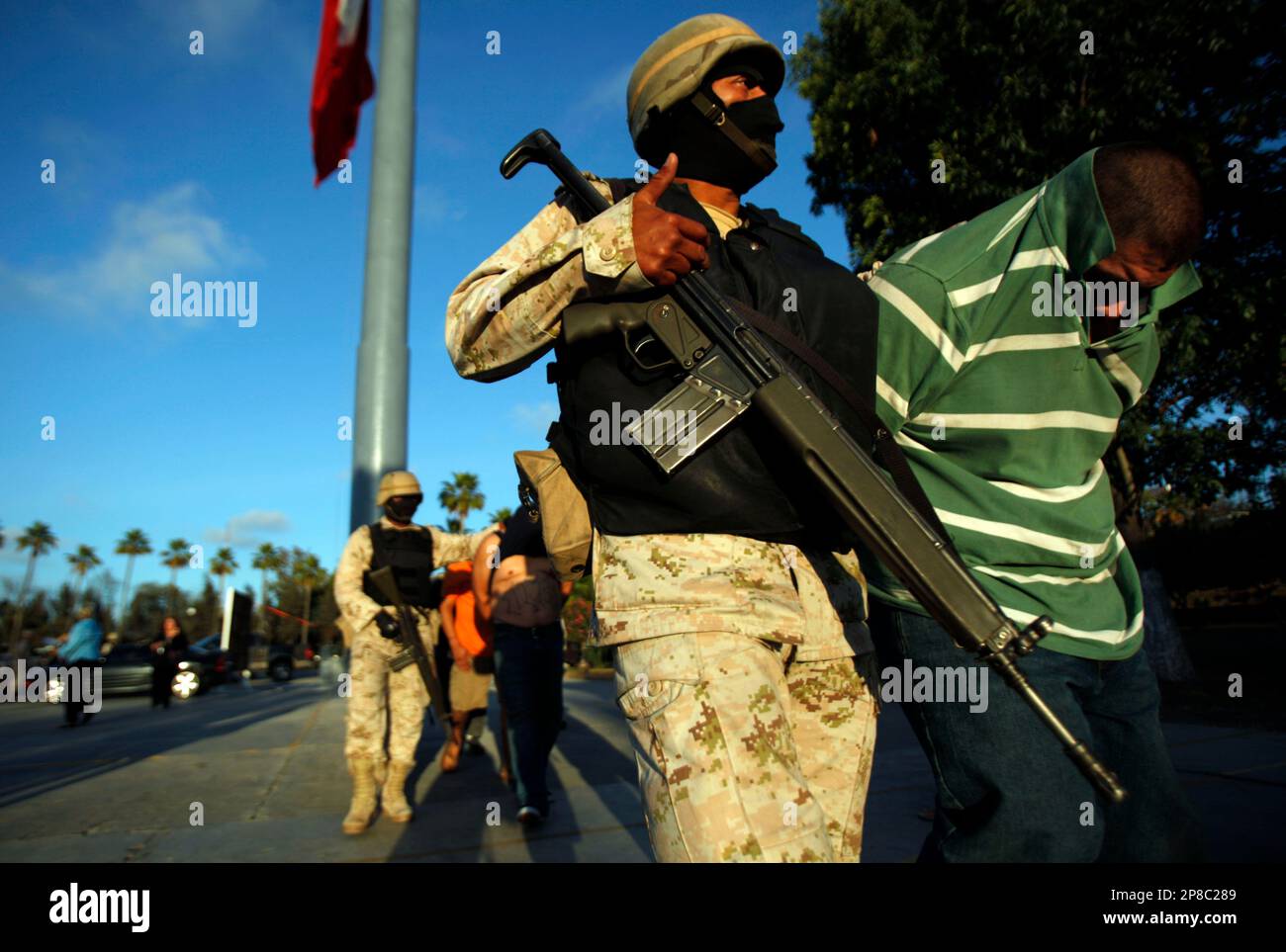 A soldier escorts Rodrigo Ramirez, aka 