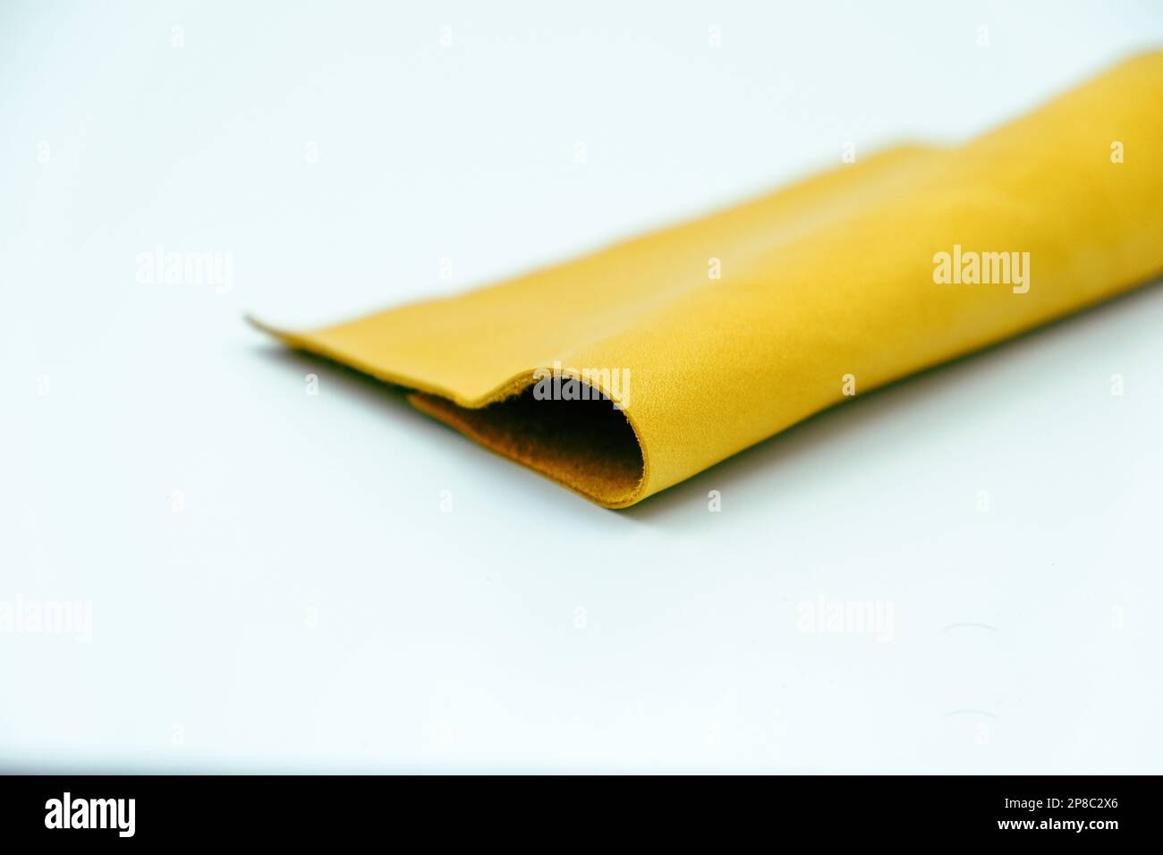 Yellow leather is folded on a white background Stock Photo