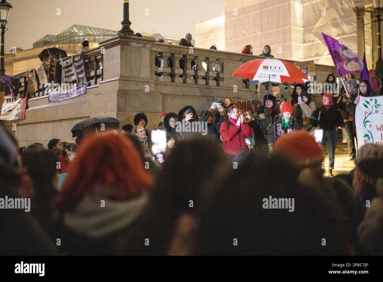 London, UK - 8 March 2023: On a cold and rainy evening, women from various backgrounds, including British, French, Iranian, Turkish, Chinese, Mexican, Afghan, and numerous other nationalities and groups, joined together in Trafalgar Square to mark International Women's Day. Credit: Sinai Noor / Alamy Live News Stock Photo