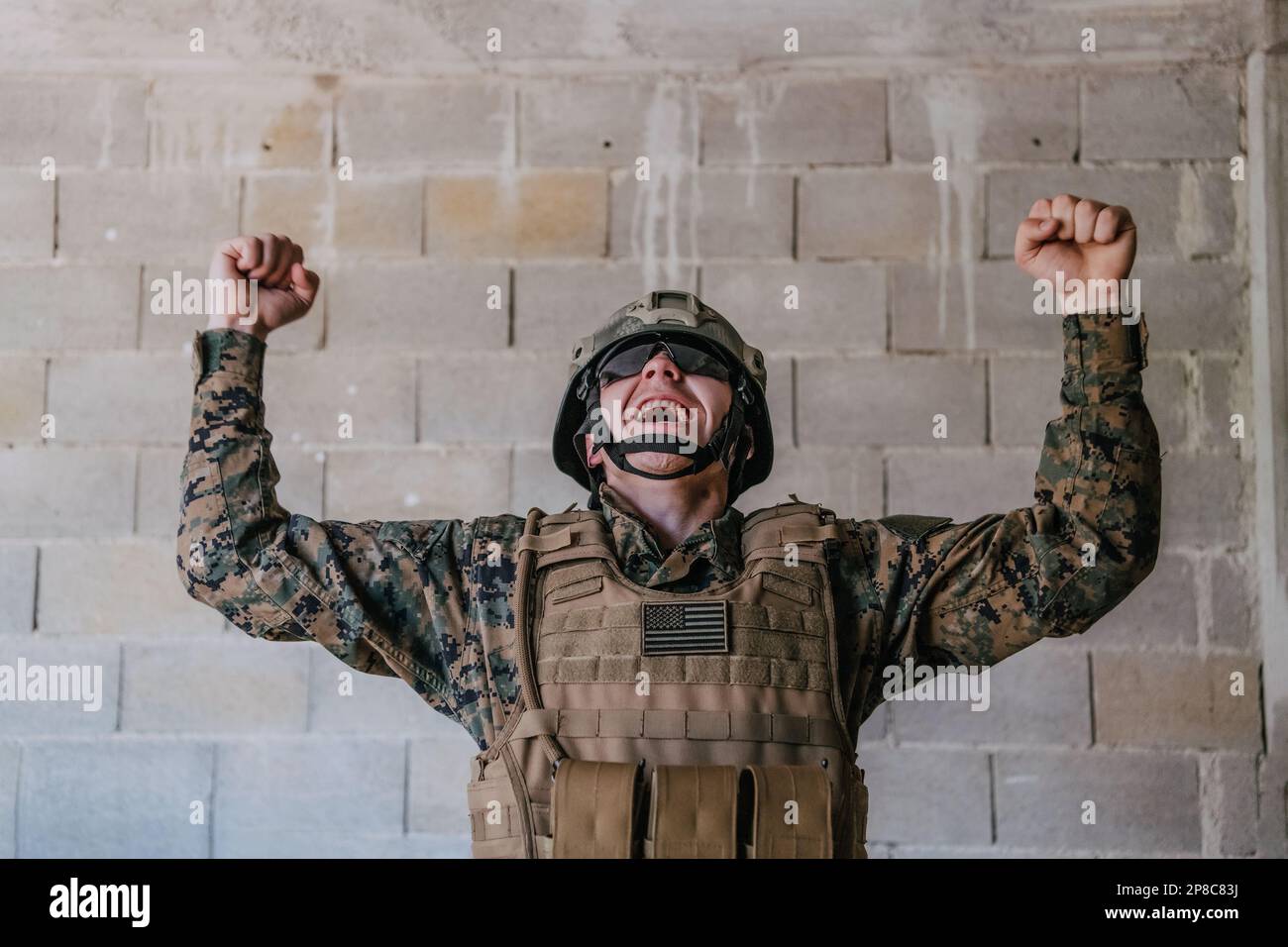 Success in the war campaign. A soldier with raised hands celebrates the ...