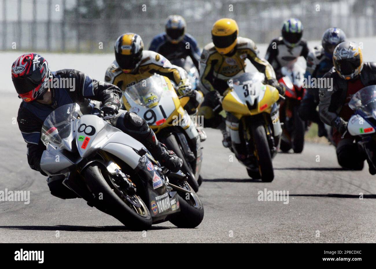 Motorcycle riders head into to the turn during races at New 
