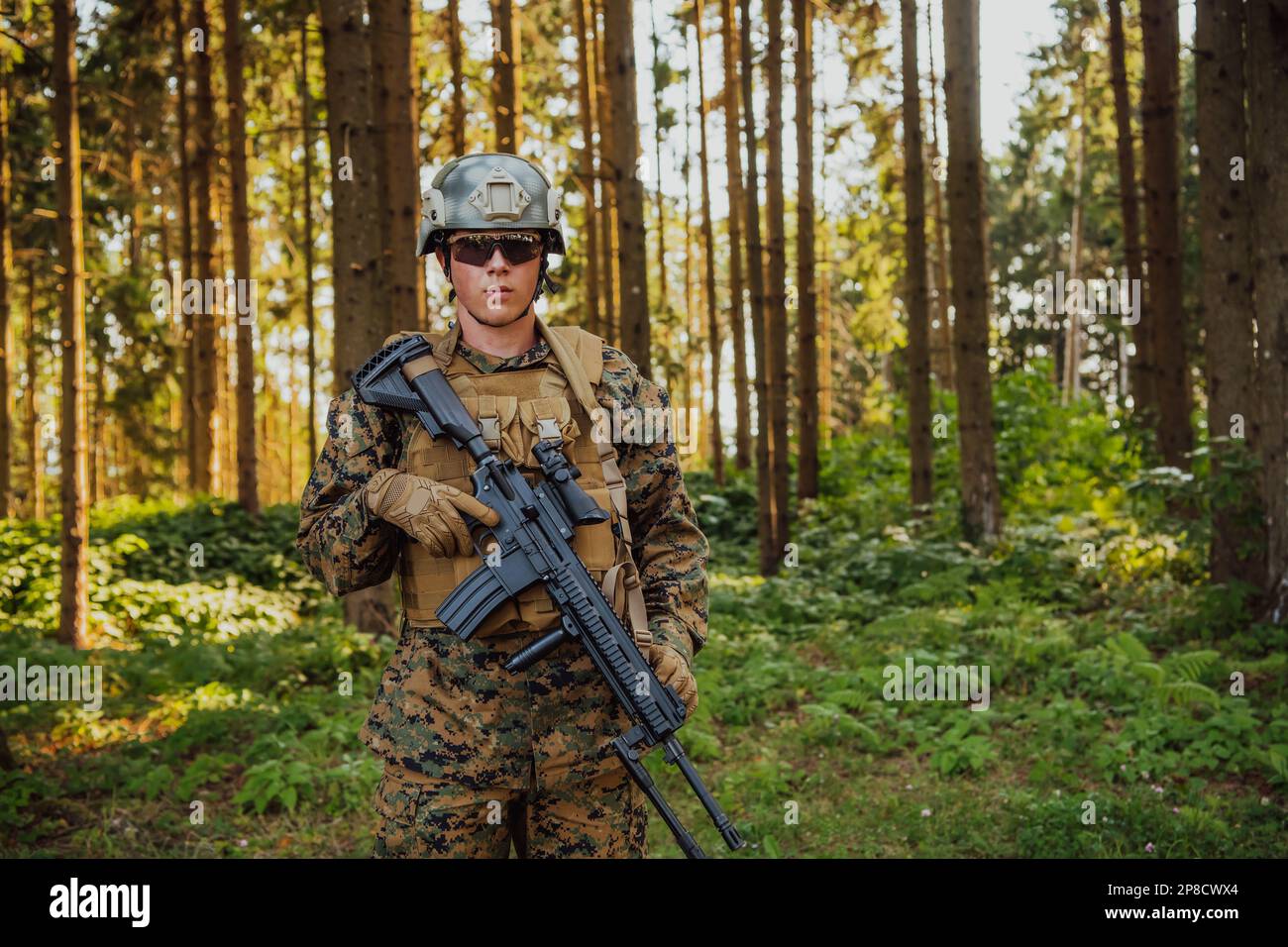 A modern warfare soldier on war duty in dense and dangerous forest ...